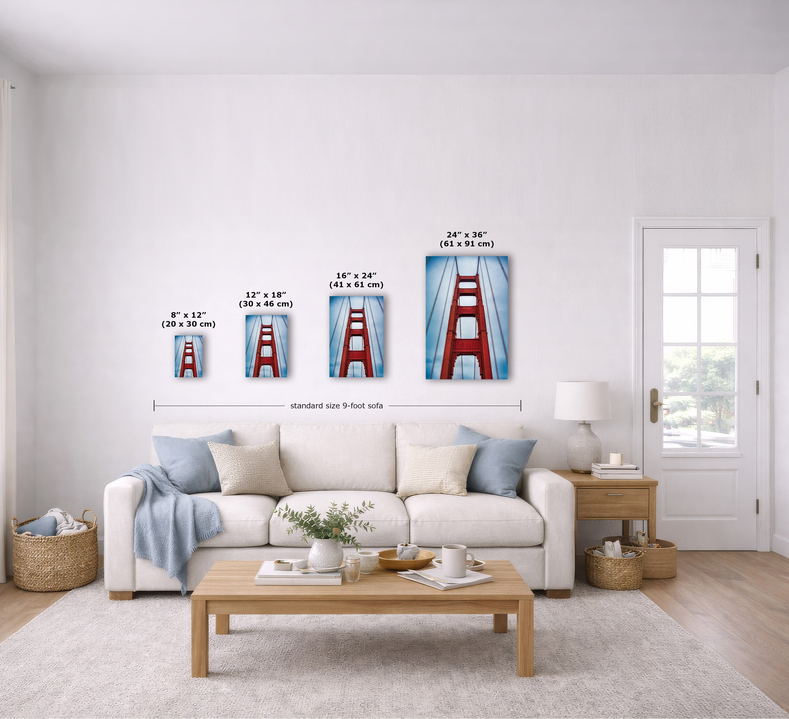 A staged living room shows a set of four vertical canvas prints of the Golden Gate Bridge in different sizes mounted on a white wall above a sofa. The prints include dimensions labeled 8" x 12", 12" x 18", 16" x 24", and 24" x 36", with a measurement line across the set.