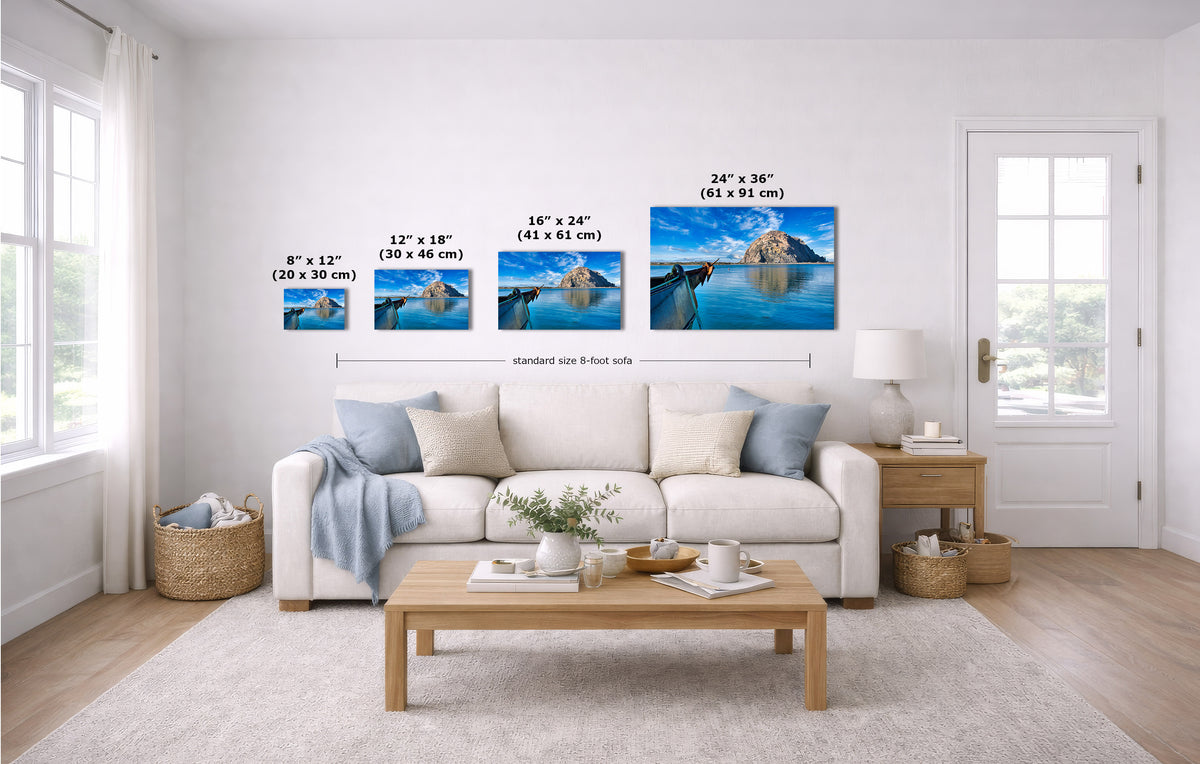 A staged living room shows four wall art prints above a white sofa, each with size text labels. The prints depict a blue mountain lake landscape.