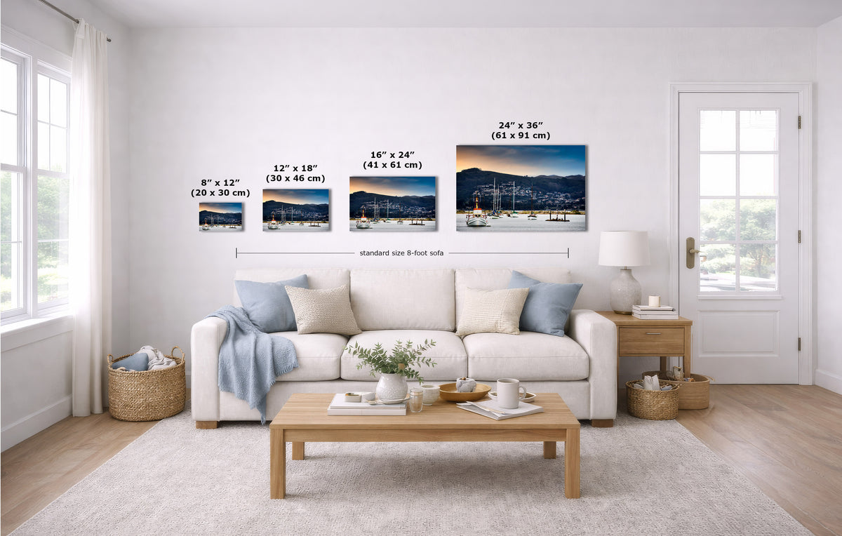 A staged living room shows a white sofa, coffee table, rug, and wall art. The wall art consists of four coastal landscape prints with overlaid size labels: 8 x 12, 12 x 18, 16 x 24, and 24 x 30 inches.