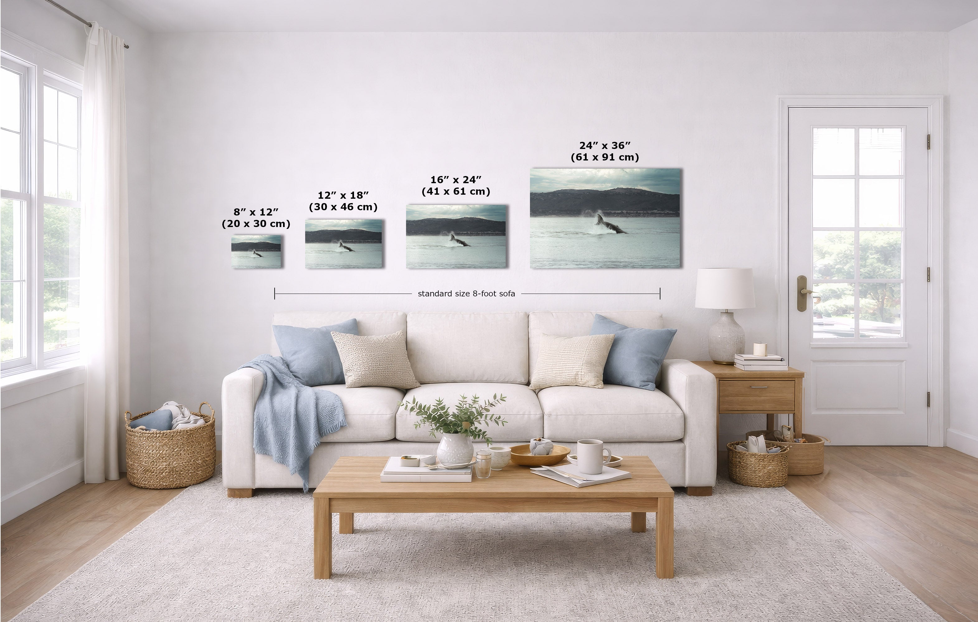 A staged living room shows a white sofa, coffee table, rug, and wall art. The wall art consists of four horizontal prints with overlaid size labels and a dimension line indicating a standard 8-foot wall spacing.