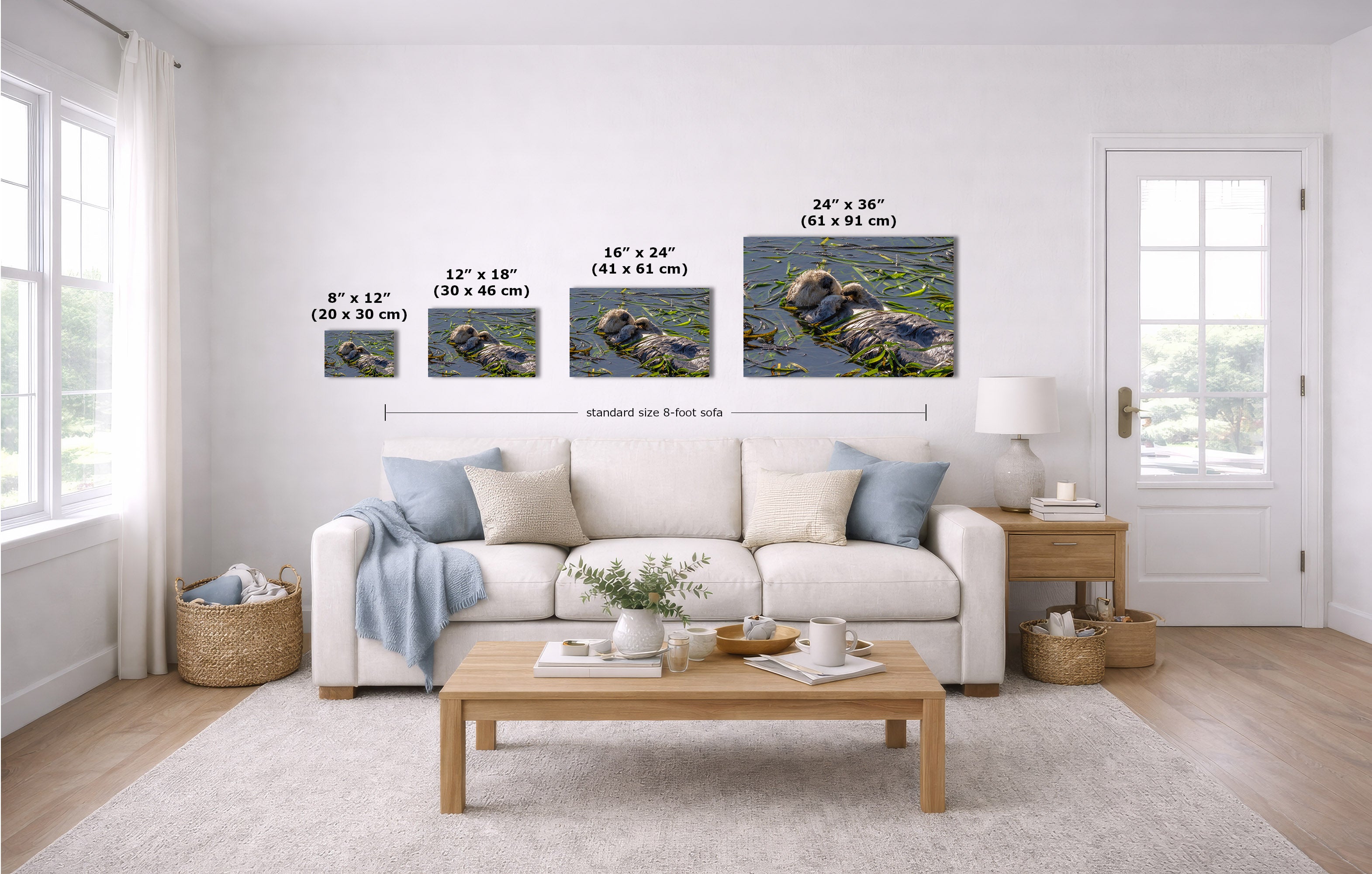 A staged living room shows a white sofa, coffee table, and wall-mounted framed artwork above the couch. The artwork consists of four square nature prints depicting rocks and water with overlaid size labels: 8 x 12, 12 x 18, 16 x 24, and 24 x 36 inches.