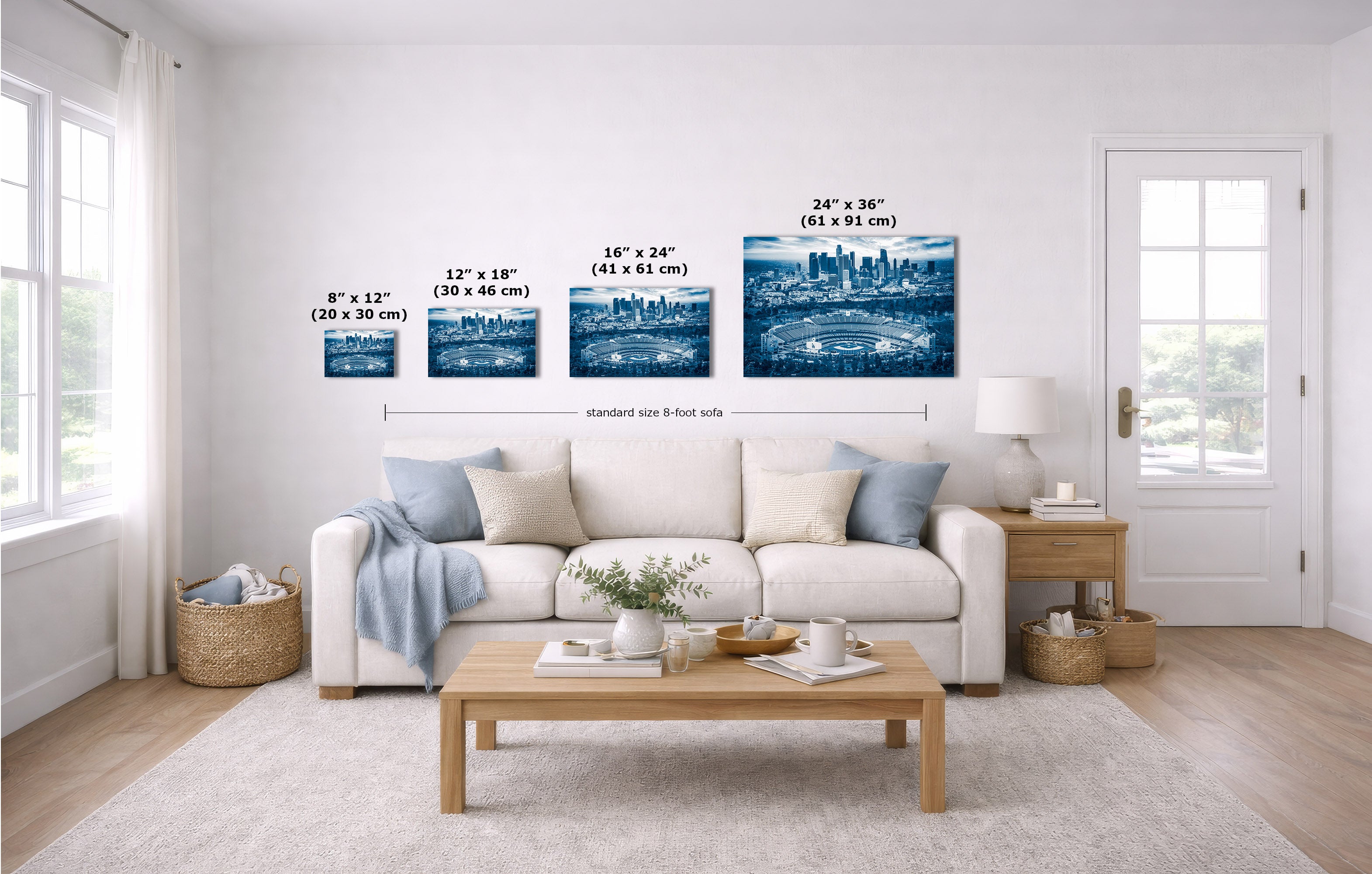 A staged living room shows four framed blue-toned city skyline wall art pieces above a white sofa, with size labels and dimension lines indicating the dimensions of each print.