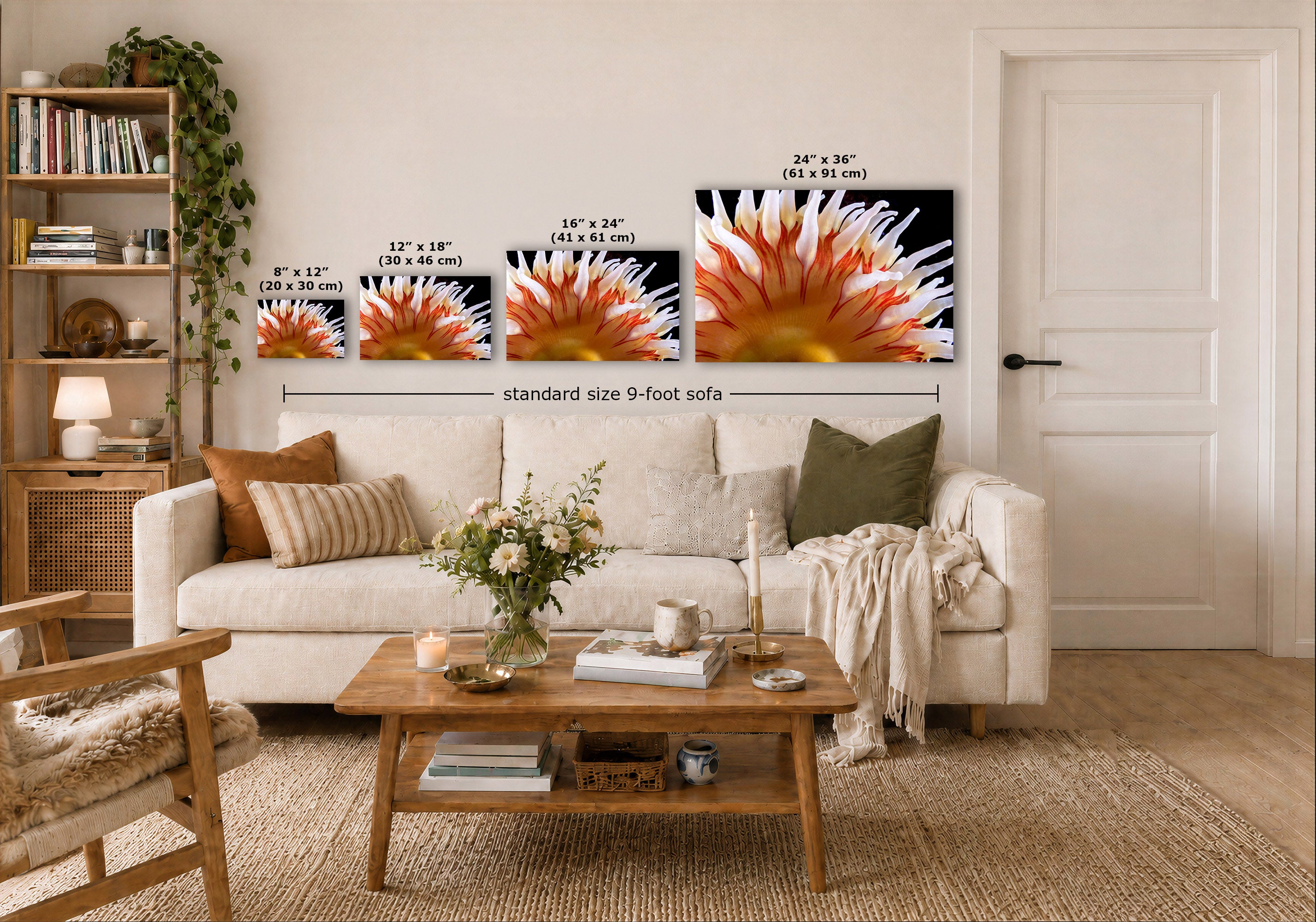 A staged living room showing three underwater wall art prints above a sofa, with size labels overlaid for each print and a dimension line reading standard size 9-foot sofa. The room includes a white sofa, wooden coffee table, shelving, and a white door.