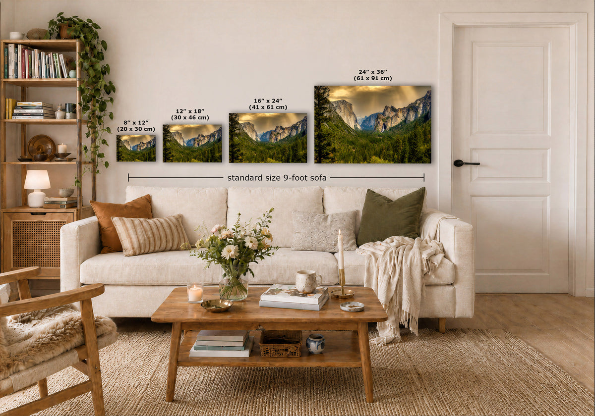 A staged living room shows mountain landscape prints mounted above a white sofa. The prints are labeled with dimensions ranging from 8 x 12 to 24 x 36 inches, with a central label reading 'standard size 9-foot sofa.