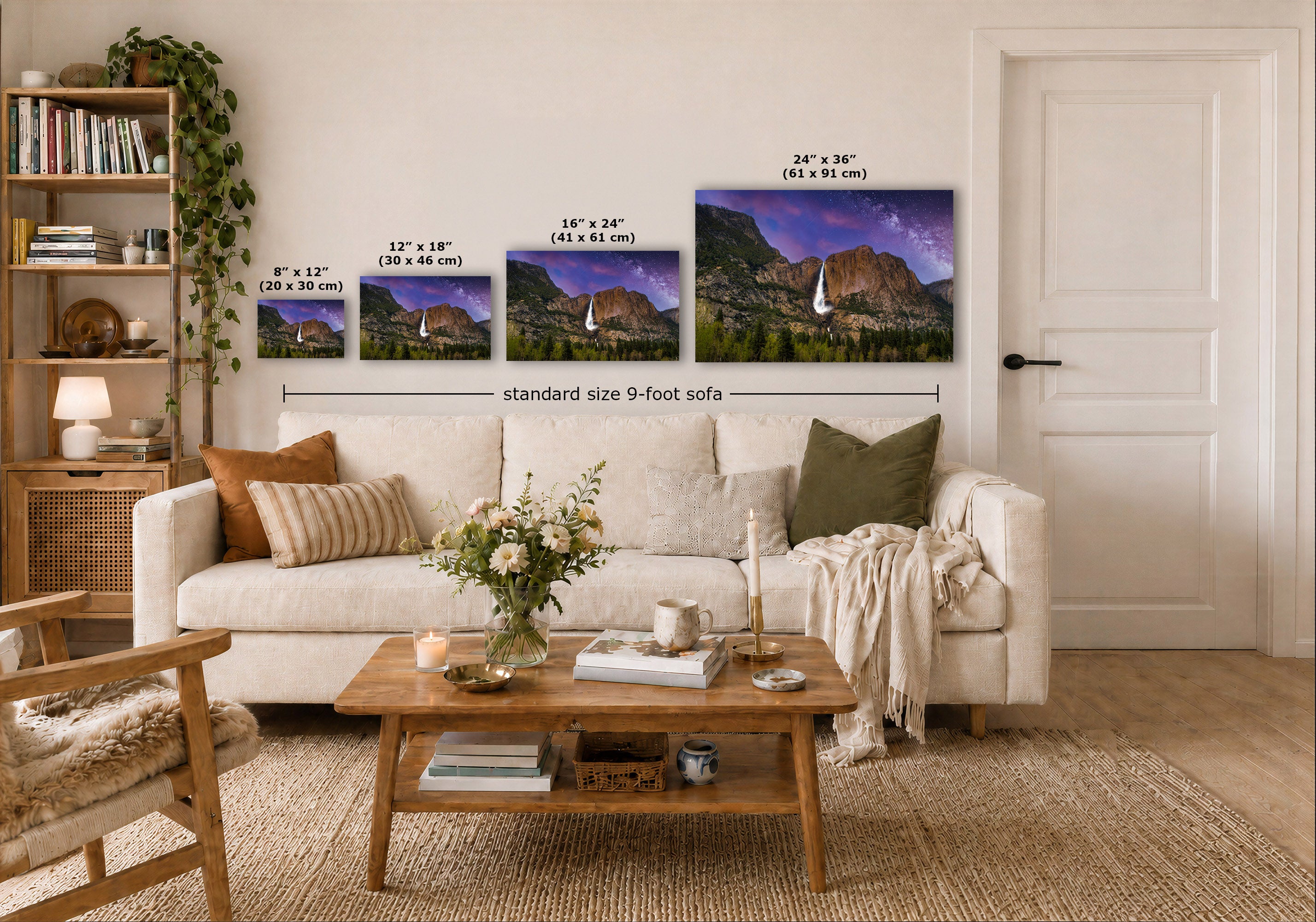 A styled living room showing four wall art prints of a mountain landscape in different sizes above a white sofa, with dimension labels indicating 8 x 12, 12 x 18, 16 x 24, and 24 x 36 sizes. The prints are part of a larger scene with a coffee table, bookshelf, and door.
