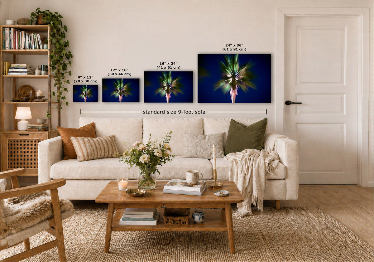 A staged living room shows a white sofa with pillows, a wooden coffee table, shelving, and a door, with four wall art prints above the sofa displaying palm tree artwork and size labels including 'standard size 9-foot sofa'.