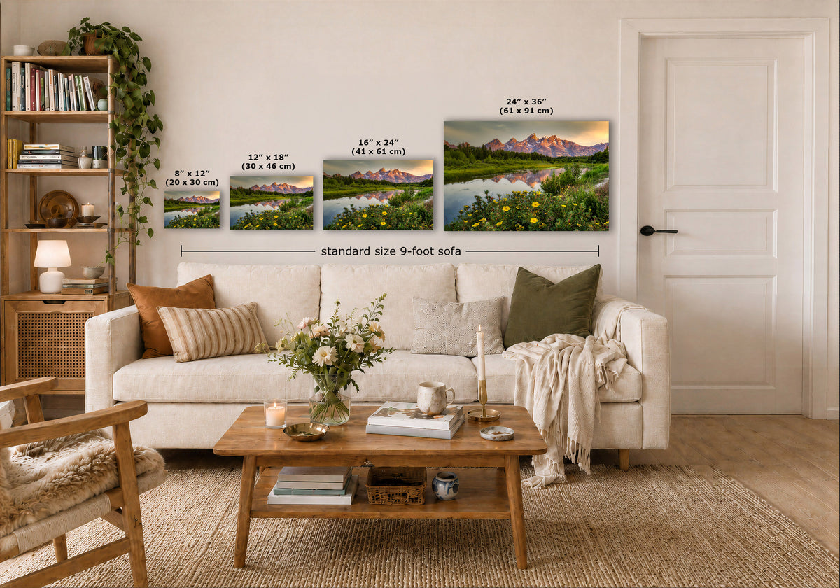 A staged living room shows a white sofa, wooden coffee table, shelving, and a wall with four landscape prints above the couch. The prints include size labels and a dimension line reading standard size 9-foot sofa.