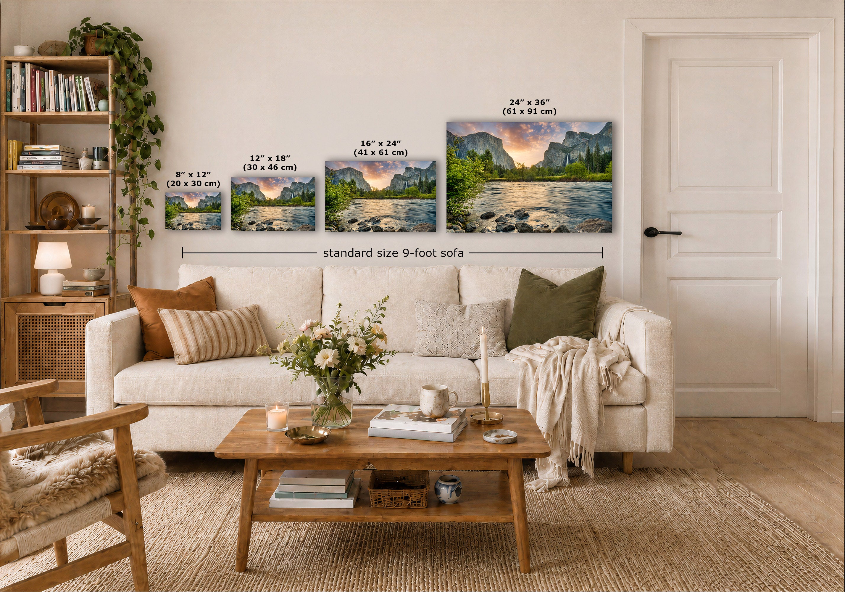 A styled living room showing three framed mountain landscape prints mounted above a white sofa, with size labels overlaid on each print and a dimension line reading standard size 9-foot sofa. The room includes a wooden coffee table, beige rug, shelving, and a white door.
