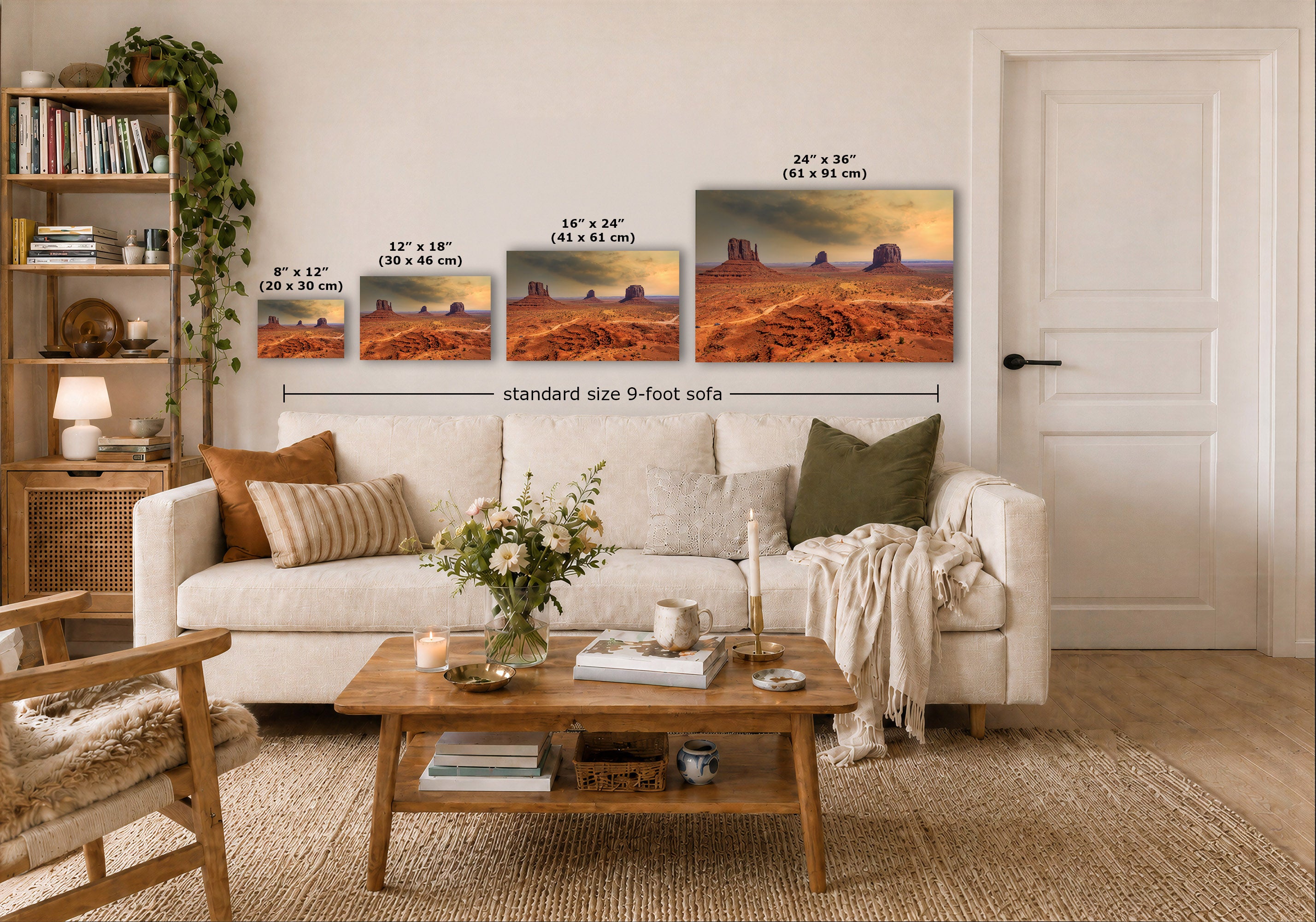 A staged living room shows a white sofa, wooden coffee table, shelving, and a wall with four desert landscape prints. Small size labels and a 'standard size 9-foot sofa' measurement line indicate the wall art dimensions relative to the sofa.