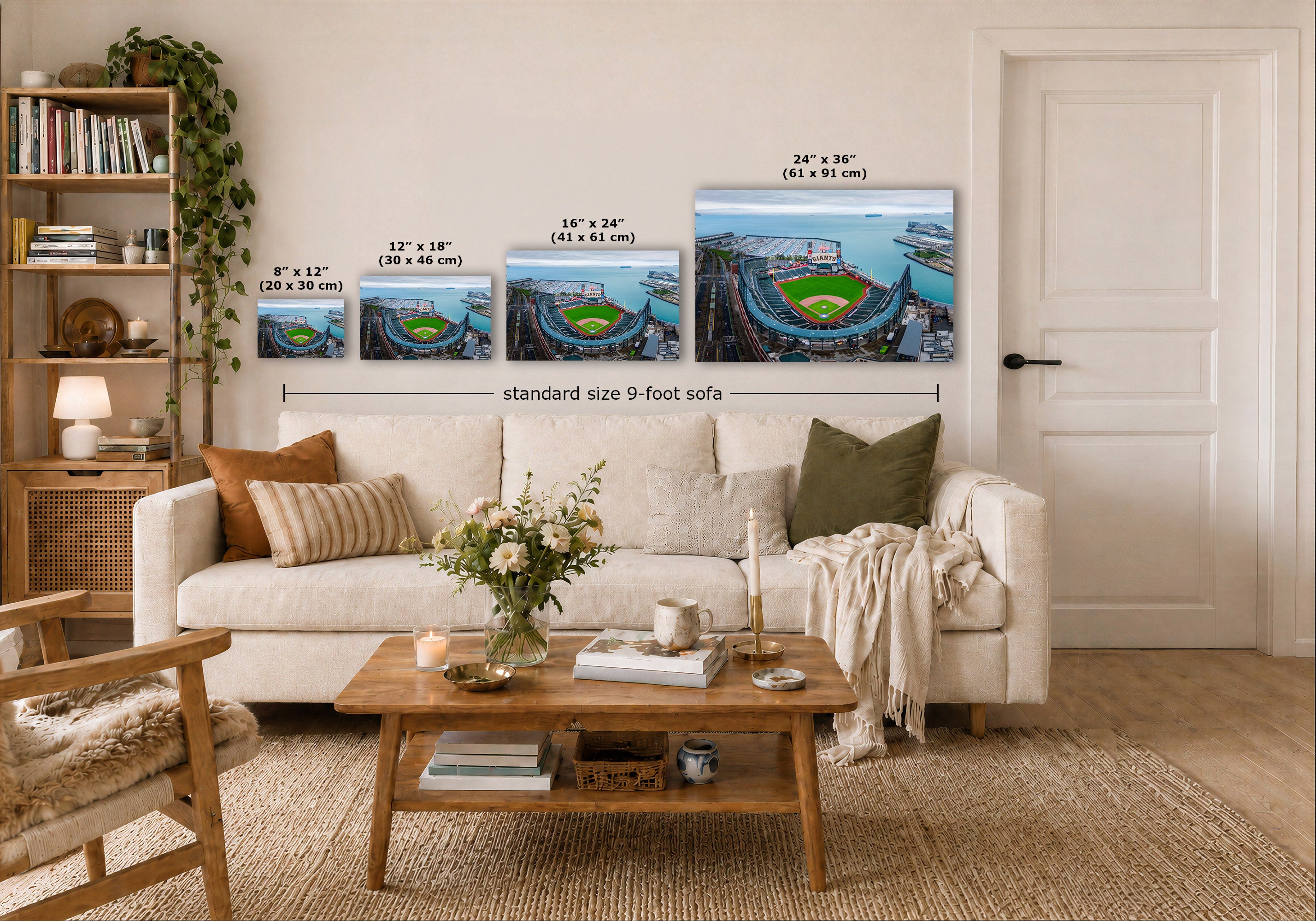 Four Oracle Park marina wall art prints showing stadium scenes are displayed above a white sofa in a styled living room. Each print includes size text in inches and centimeters, with a dimension line labeled 'standard size 9-foot sofa.