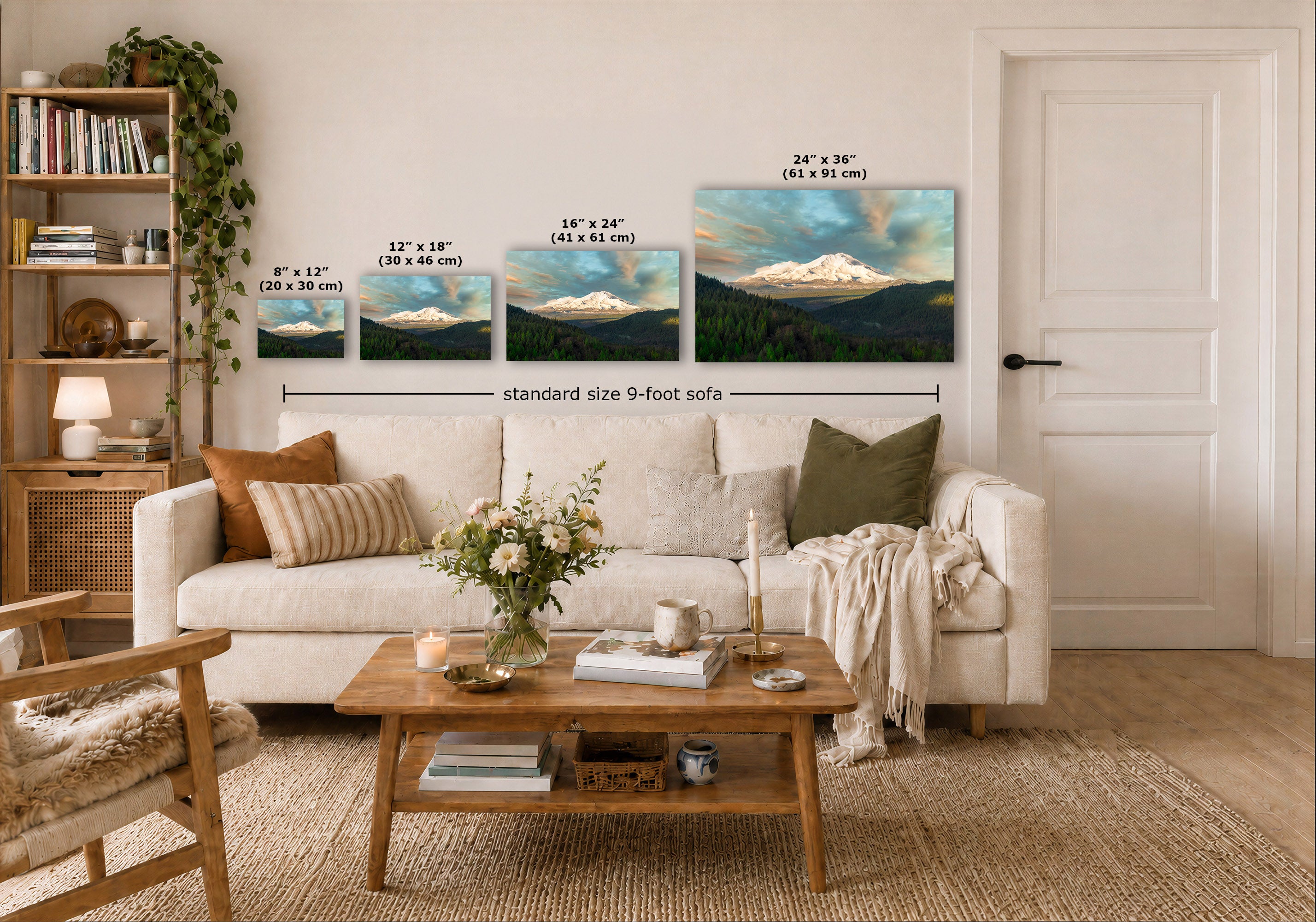 A styled living room showing four landscape wall art prints above a white sofa, with size labels for each print and a dimension callout reading standard size 9-foot sofa. The prints depict snowy mountain scenes with blue sky and dark green hills.