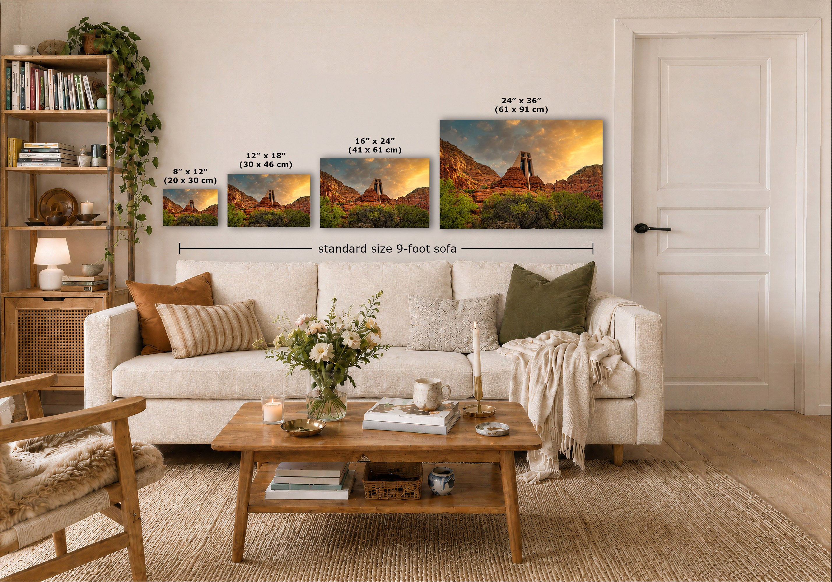 A staged living room shows a white sofa, wooden coffee table, shelving, and a large wall display of four framed landscape prints with overlaid size labels. The scene is clearly a real interior environment, so this is Lifestyle rather than Product/Packaging, even though the likely product being sold is the wall art.