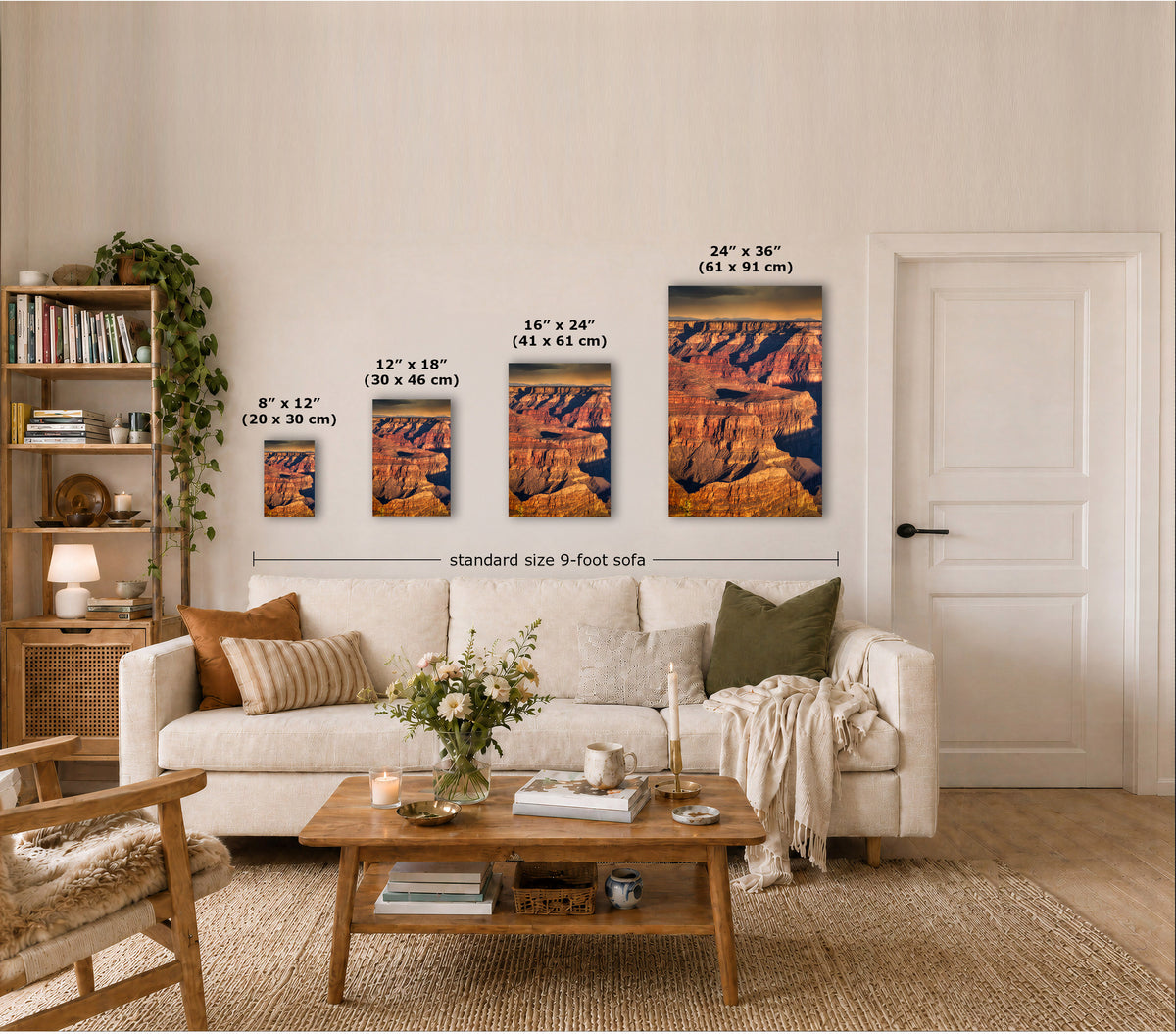 Four framed wall art prints depicting canyon landscapes are displayed above a sofa in a styled living room. Each print shows different dimensions labeled in inches and centimeters, with a dimension line reading 'standard size 9-foot sofa'.