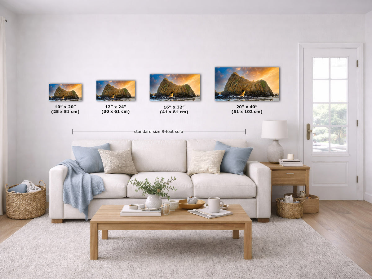 A staged living room shows four framed wall art prints above a white sofa, each with size labels underneath. The prints depict rocky mountain cliffs at sunset.