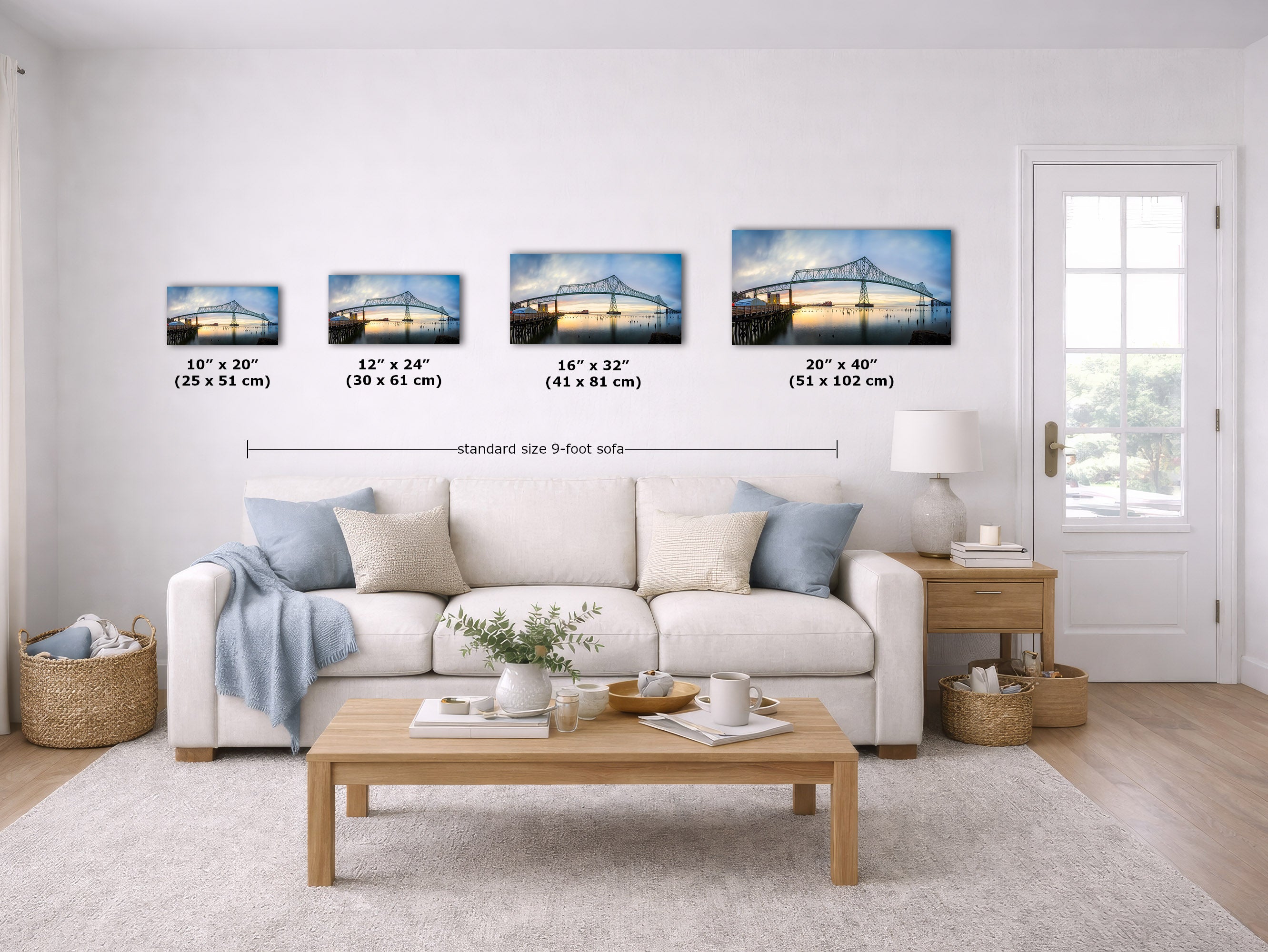 A staged living room showing four framed wall art prints above a sofa, with size labels for each print and a note for a standard 9-foot wall. The prints depict bridge scenes in blue, gray, and white tones.