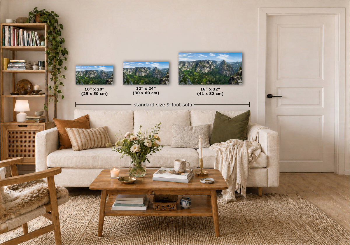 Three landscape art prints displayed above a white sofa in a styled living room, with size labels and a dimension line indicating the print width. The room includes a wooden coffee table, beige rug, bookshelf, and a white door.