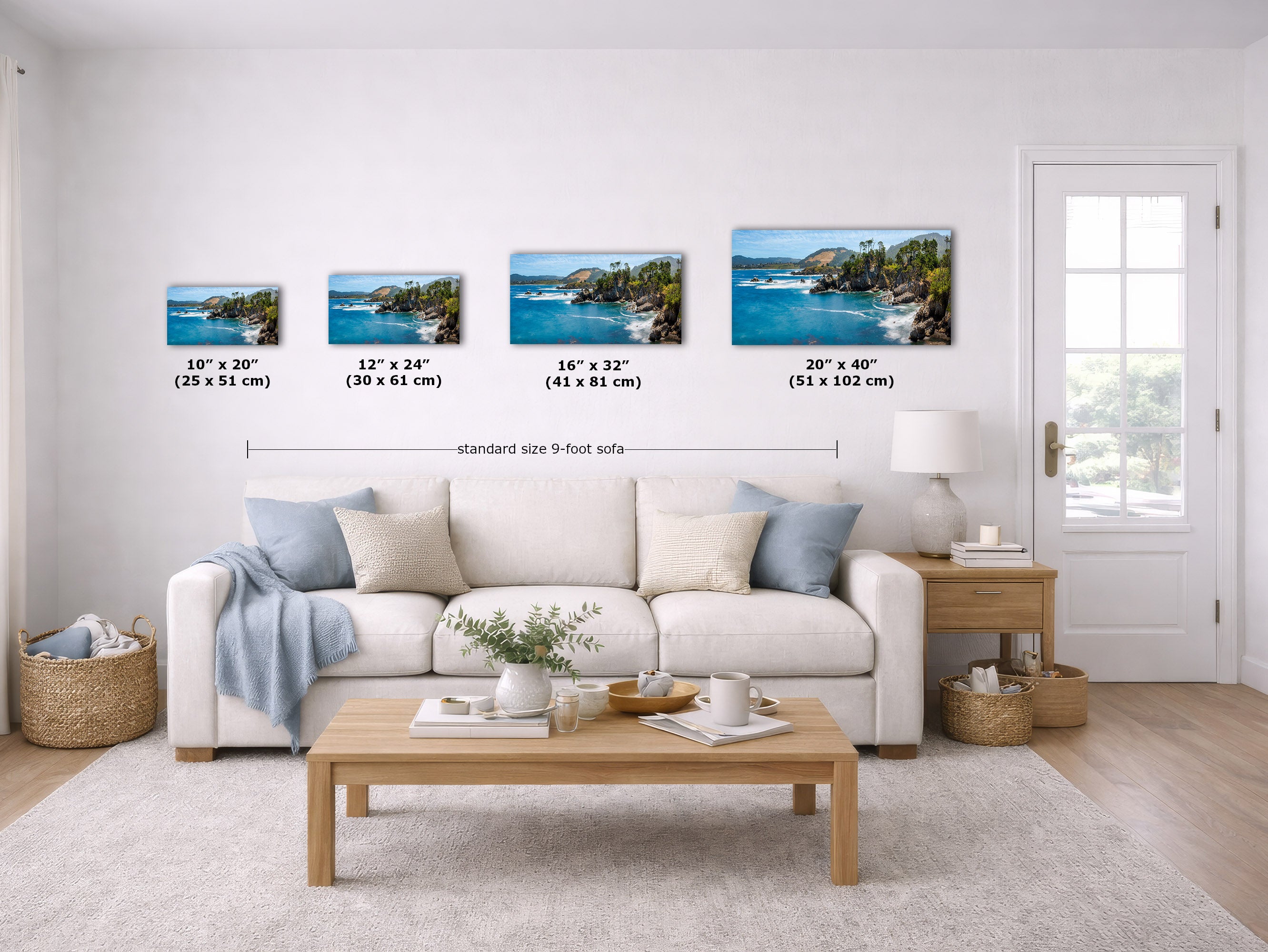 A staged living room shows four framed coastal landscape prints mounted on the wall above a sofa. The prints depict blue ocean and rocky shoreline scenes, with size labels beneath each frame and a note reading standard size 9-foot sofa.