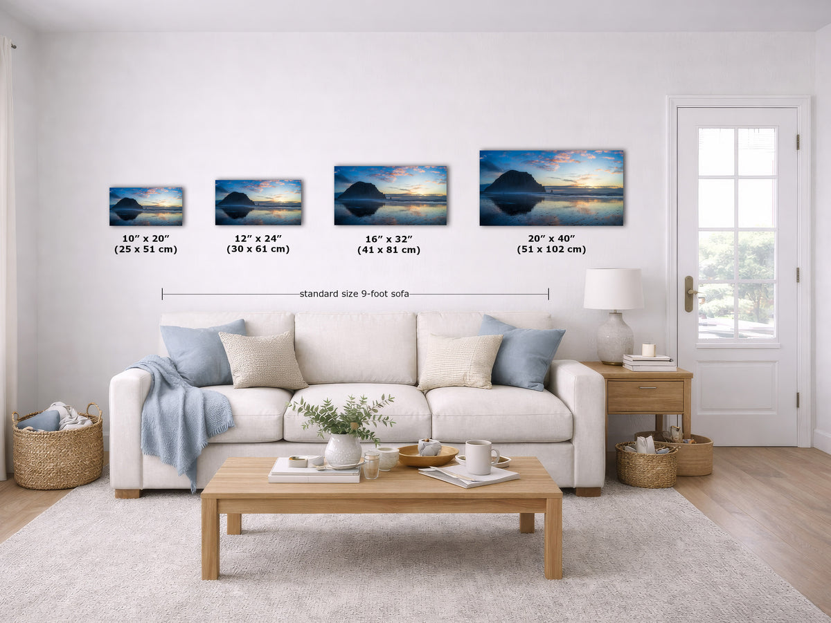 A staged living room shows four framed wall art prints above a white sofa, each labeled with dimensions (10 x 20, 12 x 24, 16 x 32, 20 x 40 inches). The prints depict a dark mountain silhouette against a sunset sky.