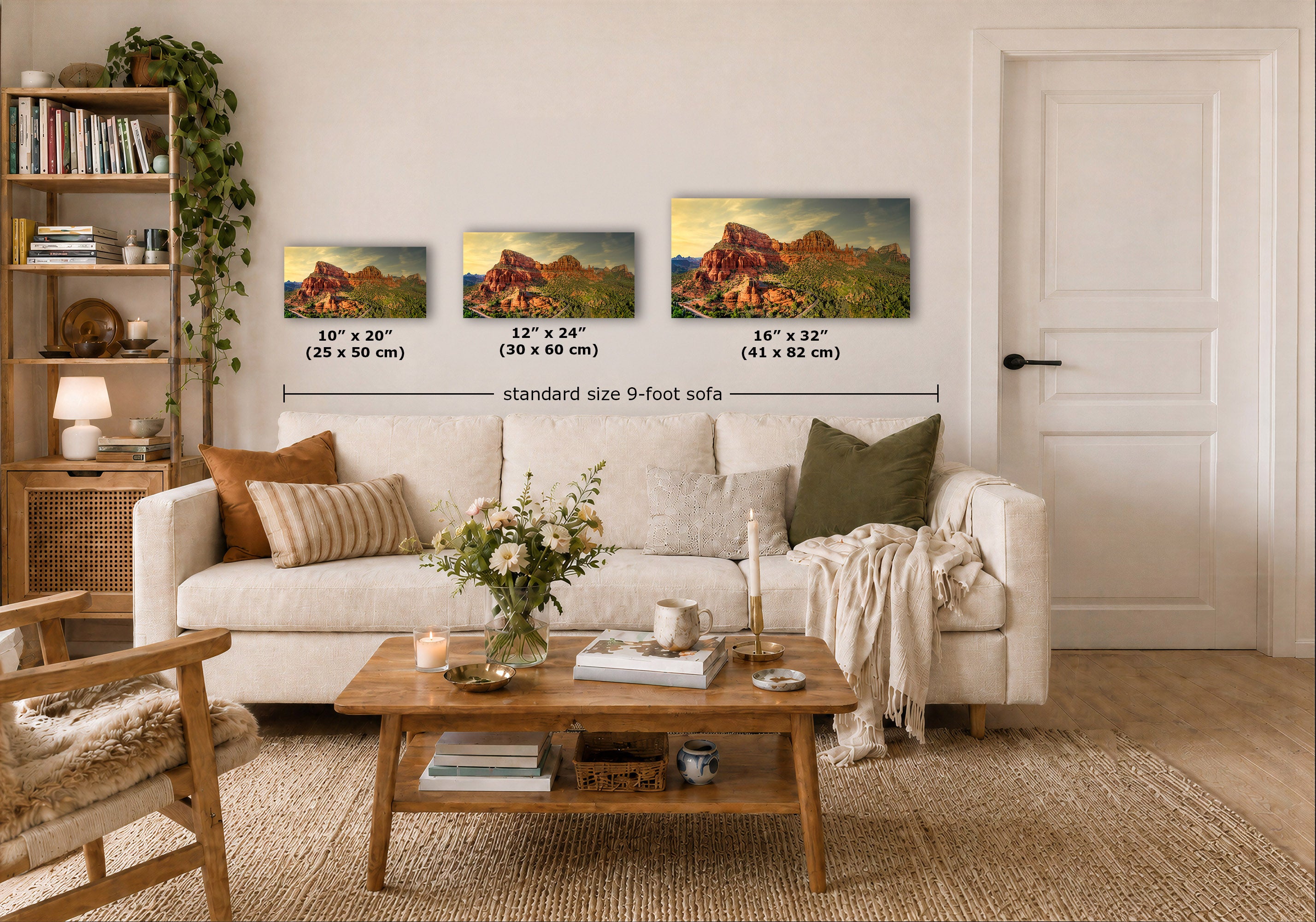 Three landscape art prints are displayed above a white sofa in a styled living room. The prints show red rock desert mountains with green and blue sky, and overlaid text indicates the dimensions: 10 x 20 inches, 12 x 24 inches, and 16 x 32 inches, with a total width label reading standard size 9-foot sofa.