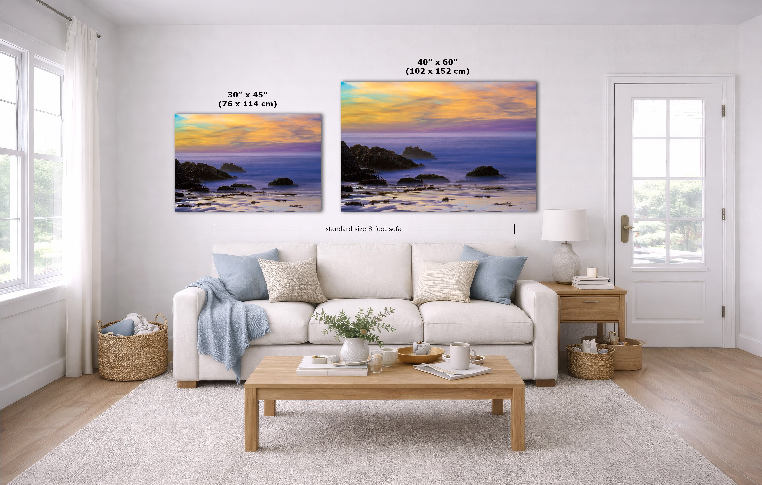 A staged living room shows two coastal landscape wall art prints above a white sofa. The left print is labeled 30 x 45 inches, and the larger right print is labeled 40 x 60 inches, with dimension arrows indicating standard size 8 feet wide.