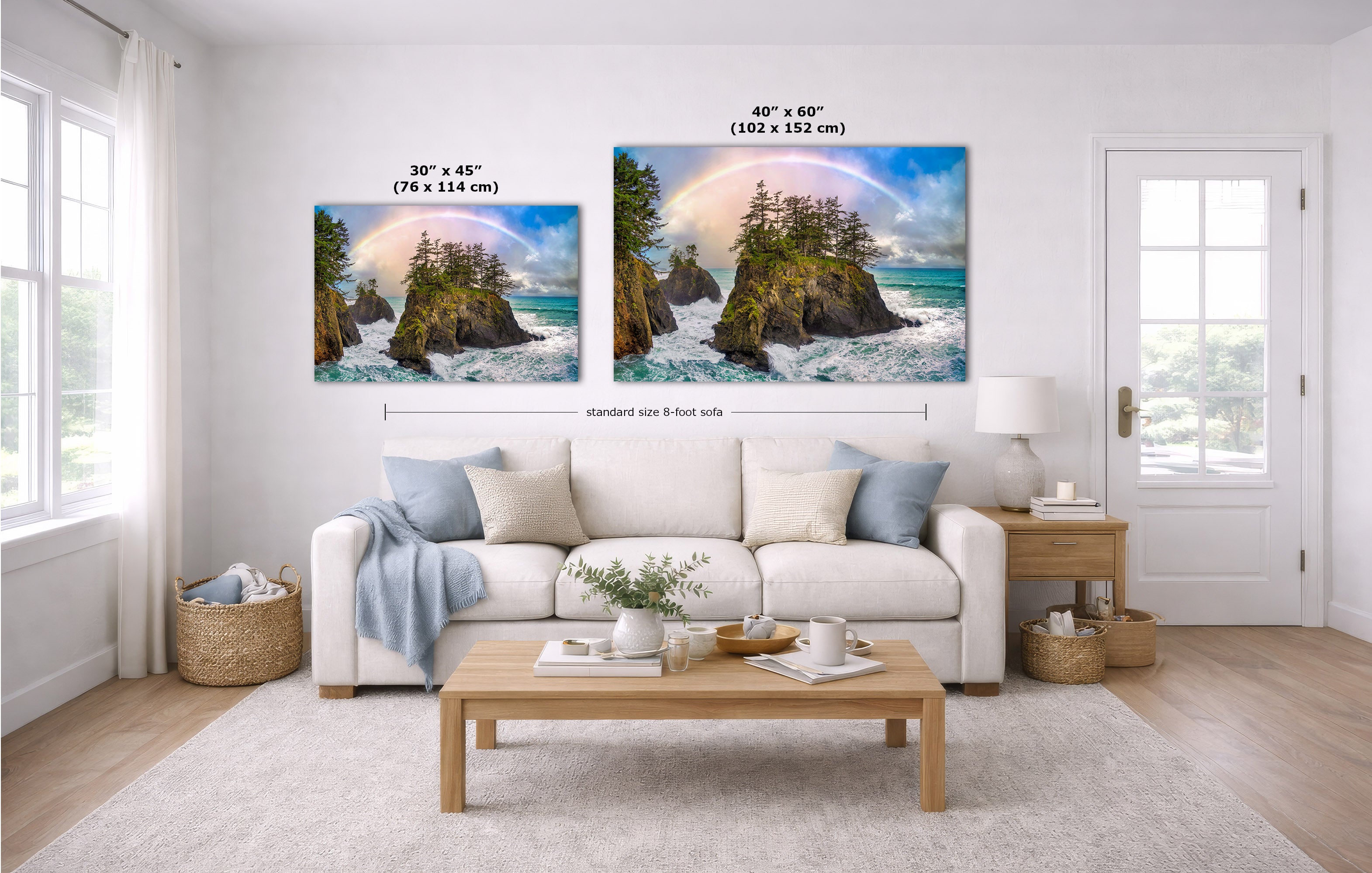 A staged living room with a white sofa, coffee table, and two coastal landscape prints above the couch. The prints show rocky cliffs, turquoise water, and rainbows, with size labels reading 30 x 45 inches and 40 x 60 inches.