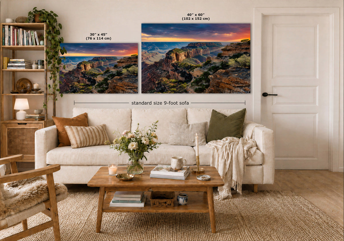 Two large Grand Canyon wall art prints displayed above a white sofa in a styled living room. The left print is labeled 30 x 45 inches, and the right print is labeled 40 x 60 inches, with a note for a standard size 9-foot sofa.