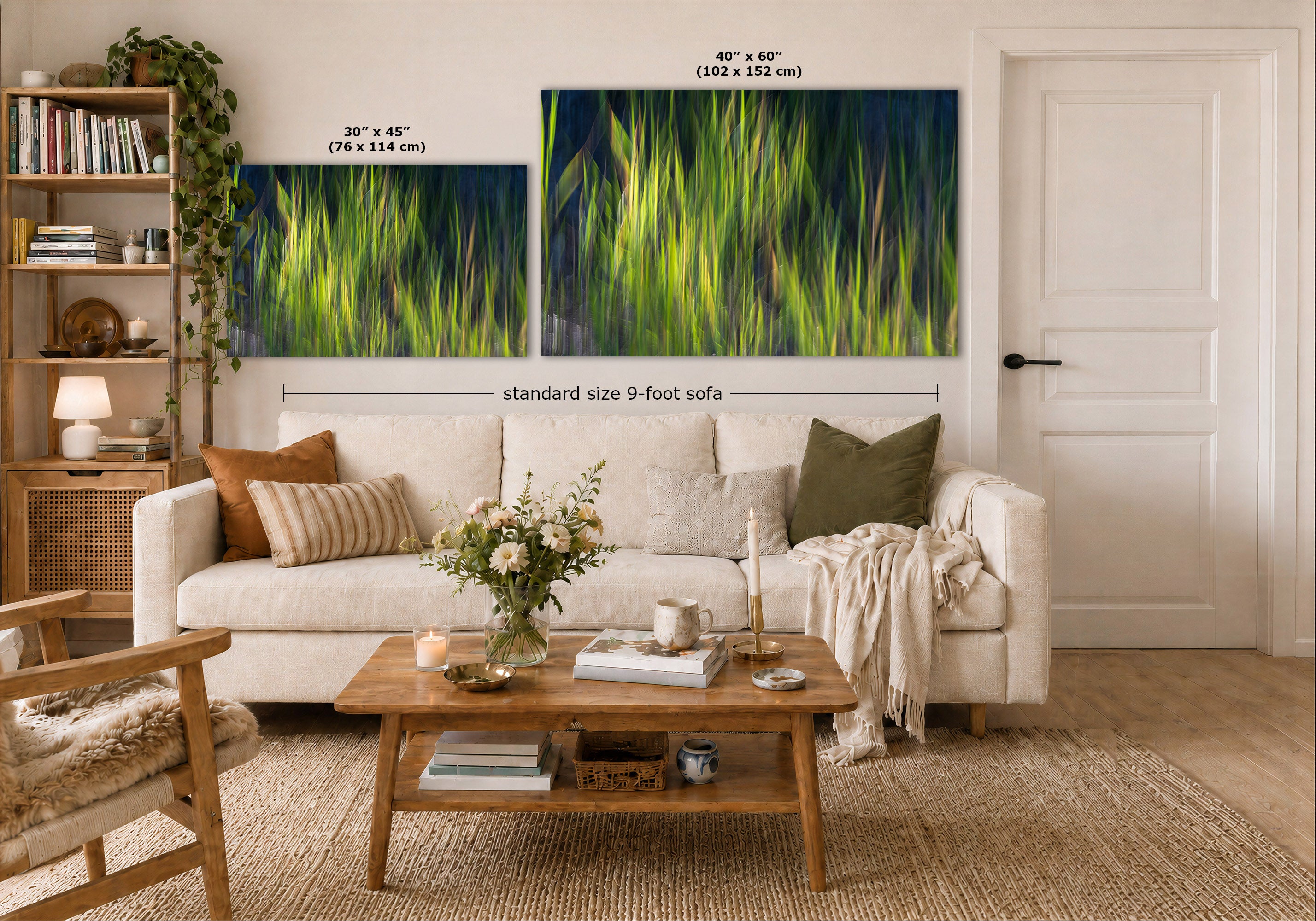 A styled living room showing two large framed wall art prints above a white sofa. The prints depict bright green grass or reeds against a dark navy blue background.