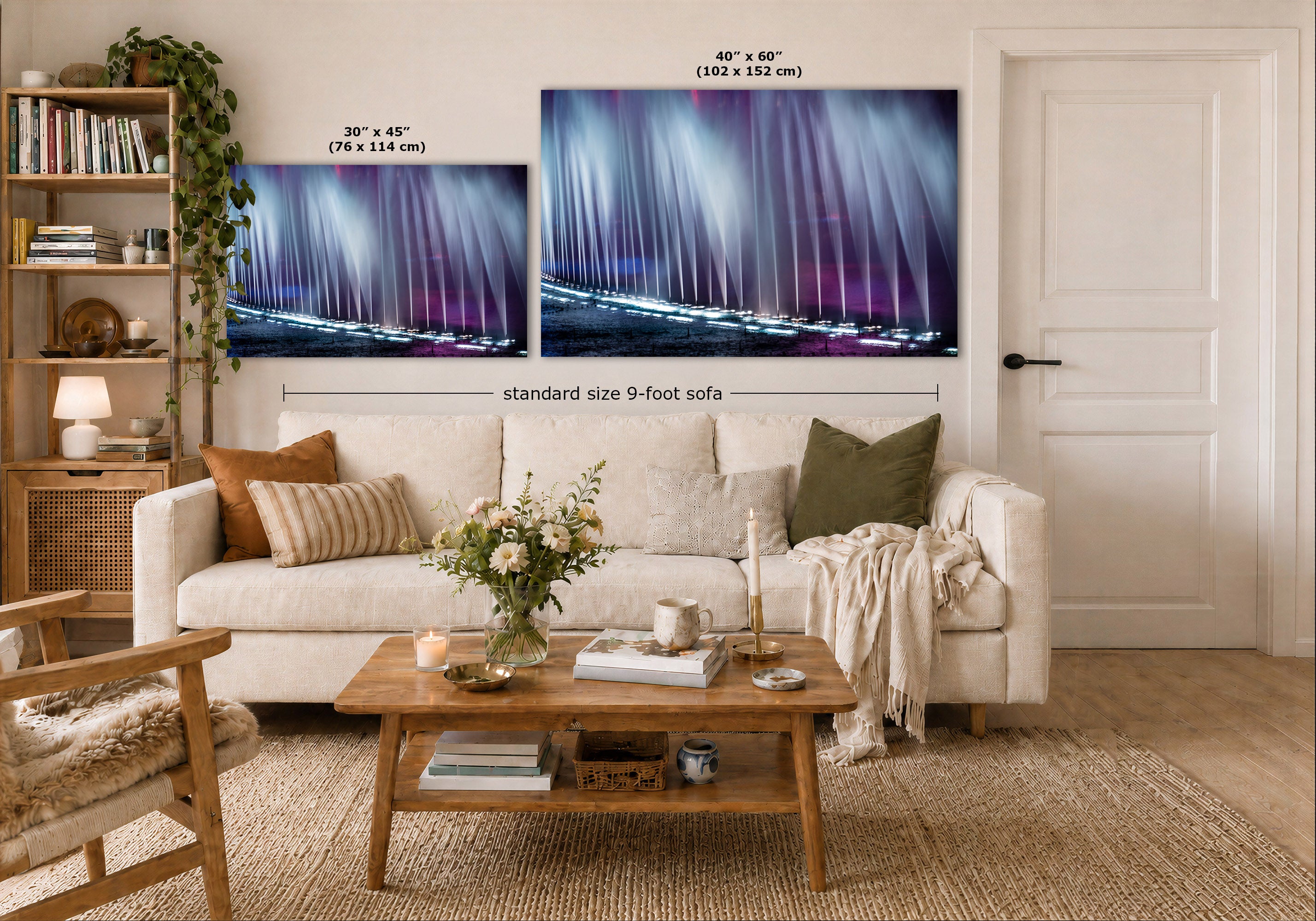A styled living room showing two abstract fountain wall art prints above a white sofa. The prints depict a dramatic purple and blue abstract water scene.
