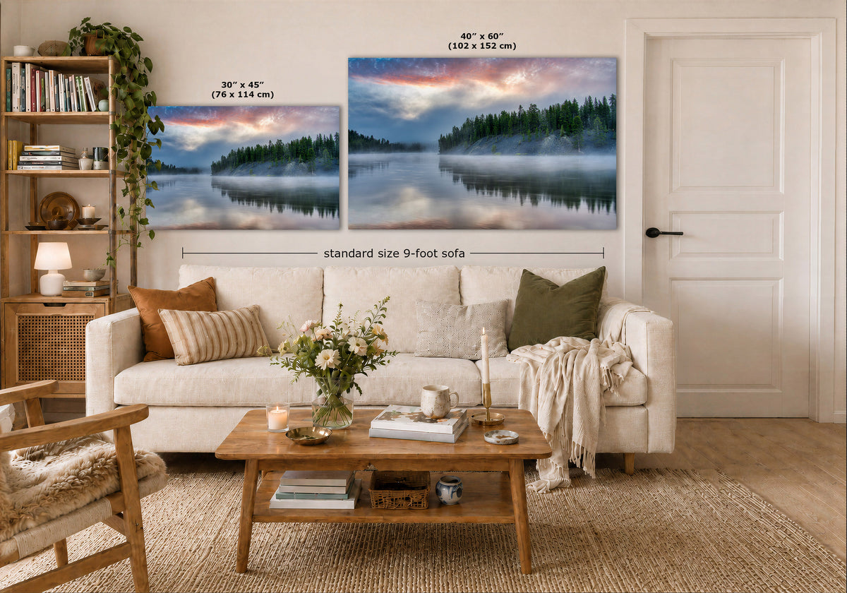 A staged living room shows two large landscape wall art prints above a white sofa. The prints depict misty forest lakes at sunrise or sunset, with size labels and a dimension callout indicating standard size 9-foot sofa spacing.