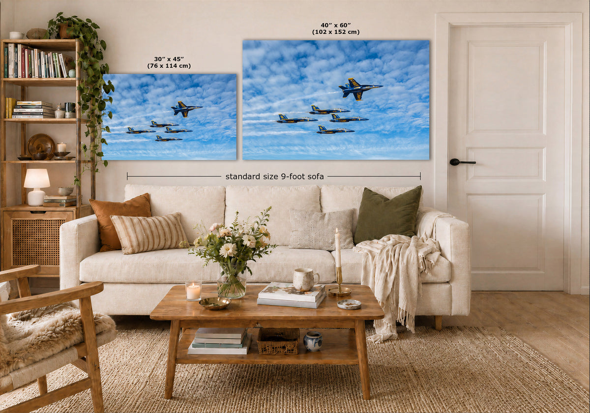 Two wall art prints showing blue sky scenes with airplanes are displayed above a white sofa in a styled living room. Text on the image indicates the sizes of the two prints and notes a standard size 9-foot sofa.