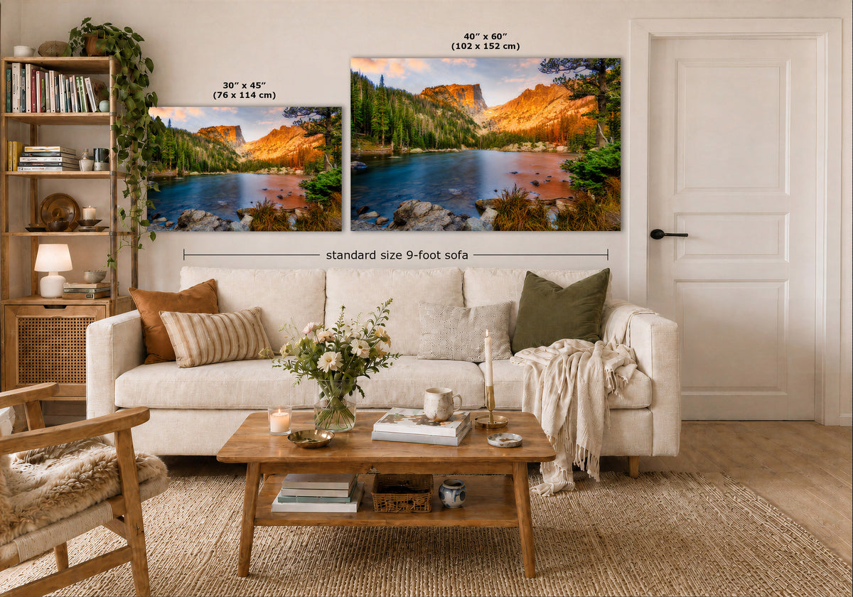 Two landscape wall art prints displayed above a white sofa in a styled living room. The left print is labeled 30 x 45 inches, and the right print is labeled 40 x 60 inches, with a dimension line indicating a standard size 9-foot sofa below.