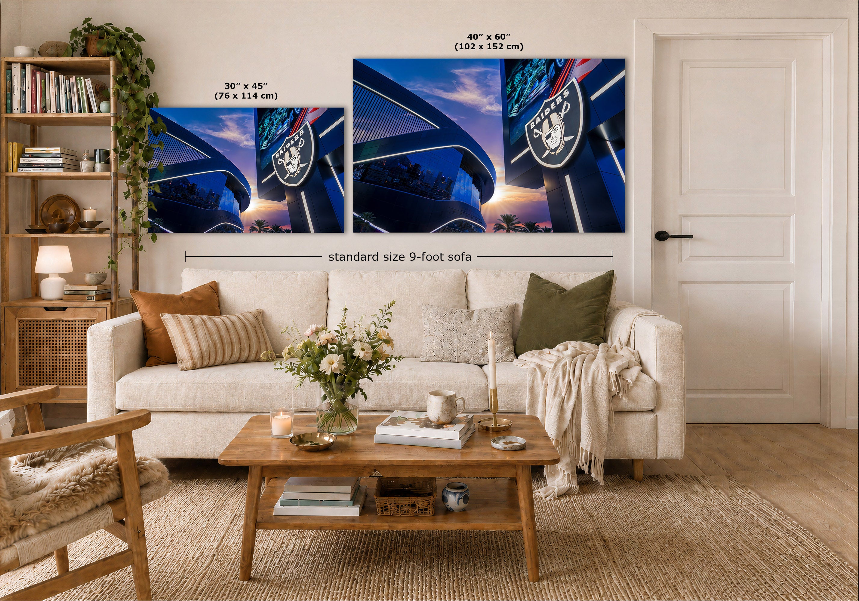 A styled living room showing two large wall art prints above a white sofa. The prints depict a blue stadium scene with the Oakland Raiders logo and size text overlays indicating 40 x 60 inches and 30 x 45 inches.