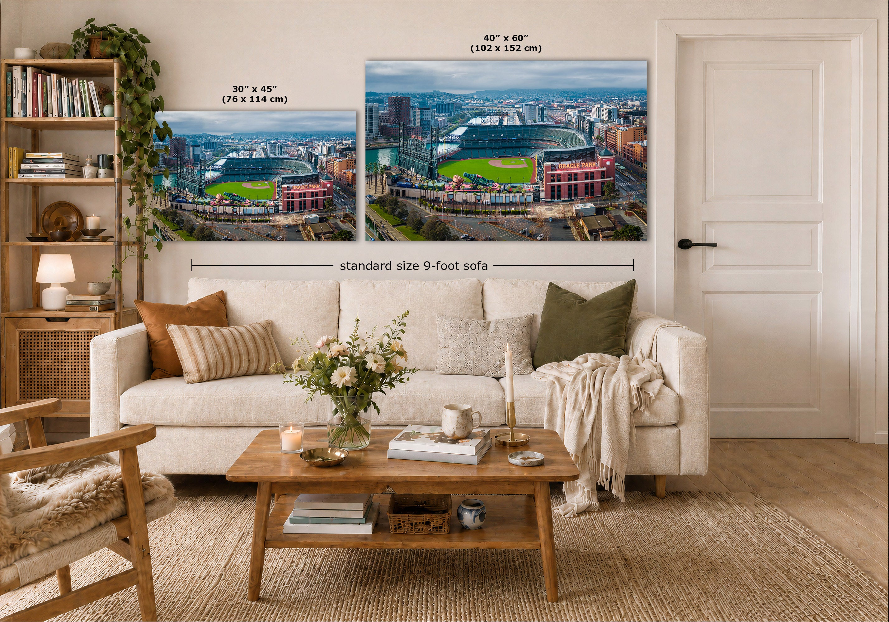 A staged living room shows two large wall art prints above a white sofa, each depicting Oracle Park and San Francisco, California. The image includes size callouts: 30 x 45 inches on the left and 40 x 60 inches on the right, plus a note about a standard size 9-foot sofa below the prints.