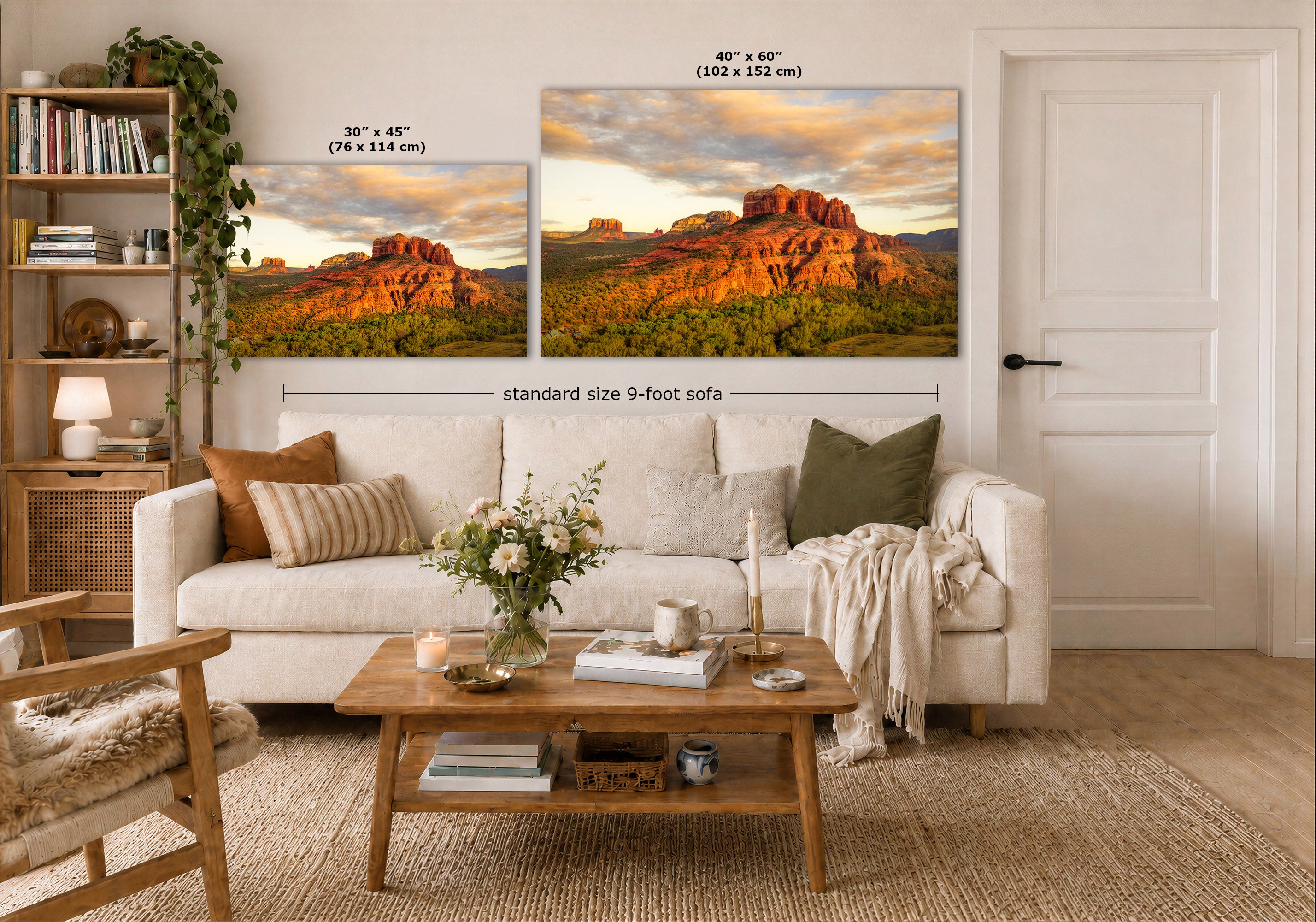 A styled living room showing two landscape wall art prints above a white sofa, with dimension labels indicating 30 x 45 inches and 40 x 60 inches sizes. The prints depict a warm sunset over red rock desert mountains and green valley terrain.