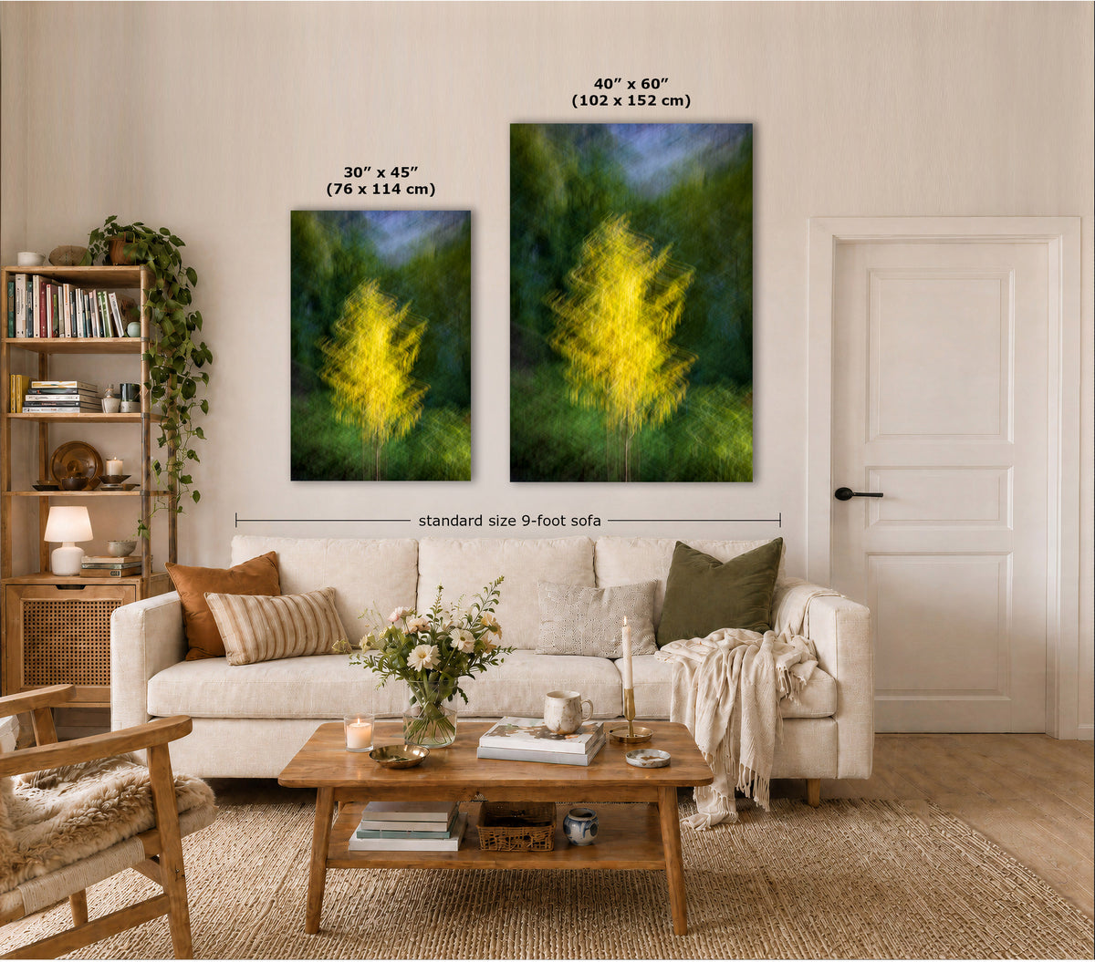 Two vertical wall art prints showing yellow trees in green and blue tones, displayed above a white sofa in a styled living room. Text labels indicate the dimensions of both prints: 30 x 45 inches and 48 x 60 inches, with a dimension line across the two prints reading standard size 9-foot sofa.