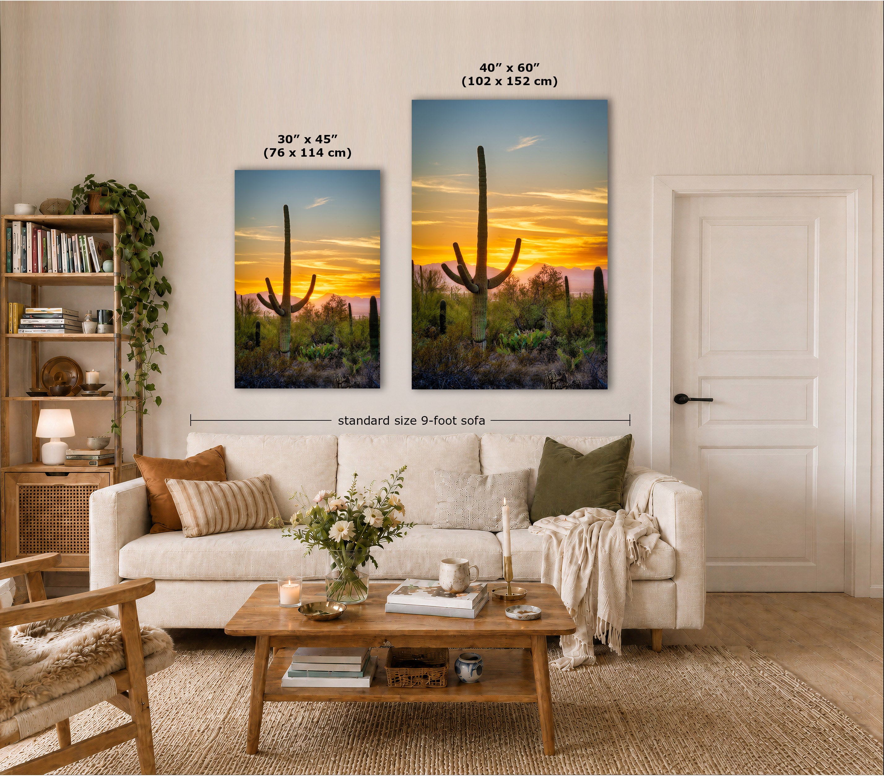 Two vertical canvas prints showing desert cacti at sunset, displayed on a wall above a beige sofa in a styled living room. Text labels indicate the two sizes: 30 x 45 inches and 40 x 60 inches, with a dimension line across the larger print noting standard size 9-foot sofa.