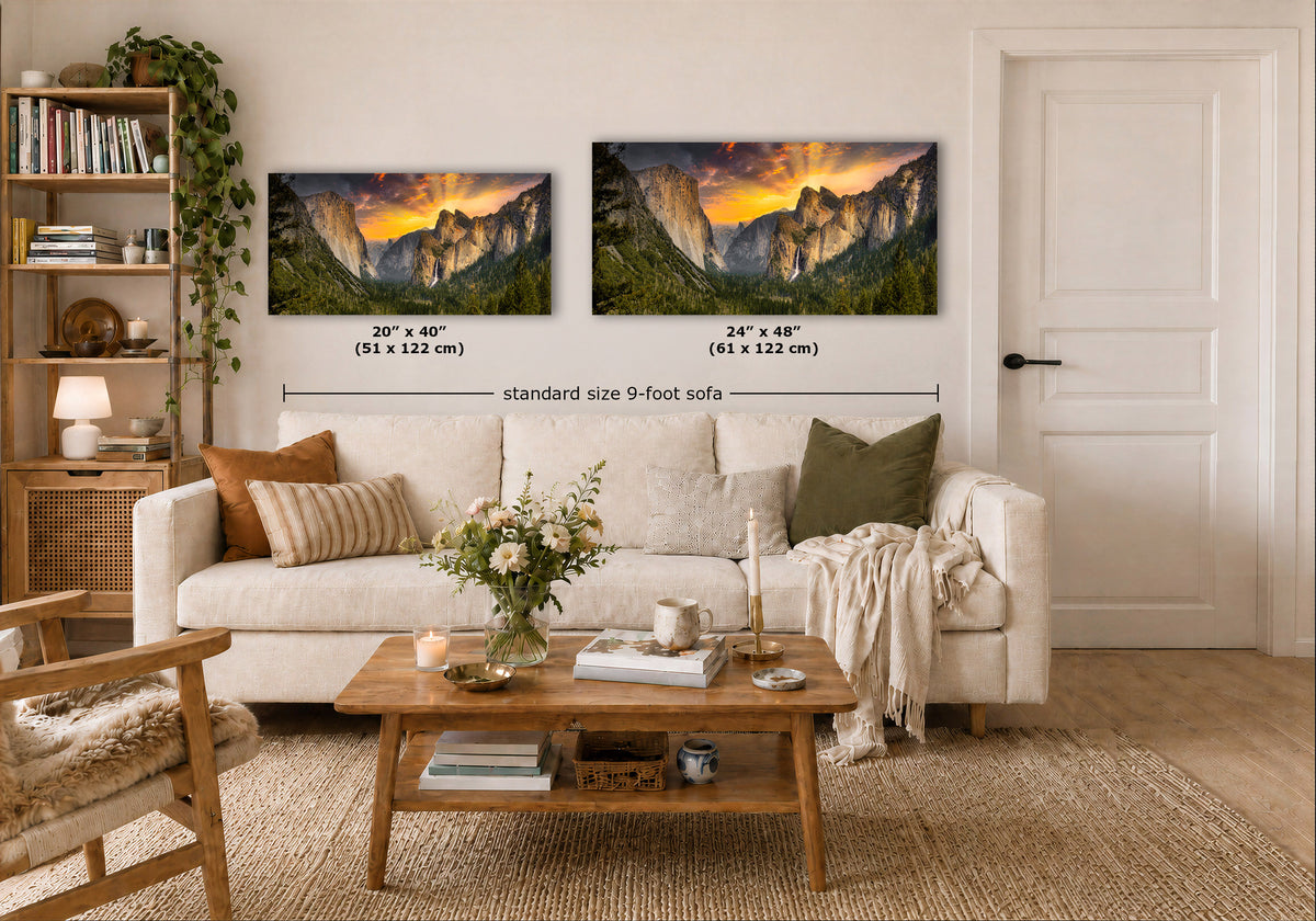 A styled living room showing two Yosemite Tunnel View wall art prints above a white sofa, with dimension labels indicating 20 x 40 in and 24 x 48 in sizes. The room includes a wooden coffee table, bookshelf, chair, and a white door on the right.