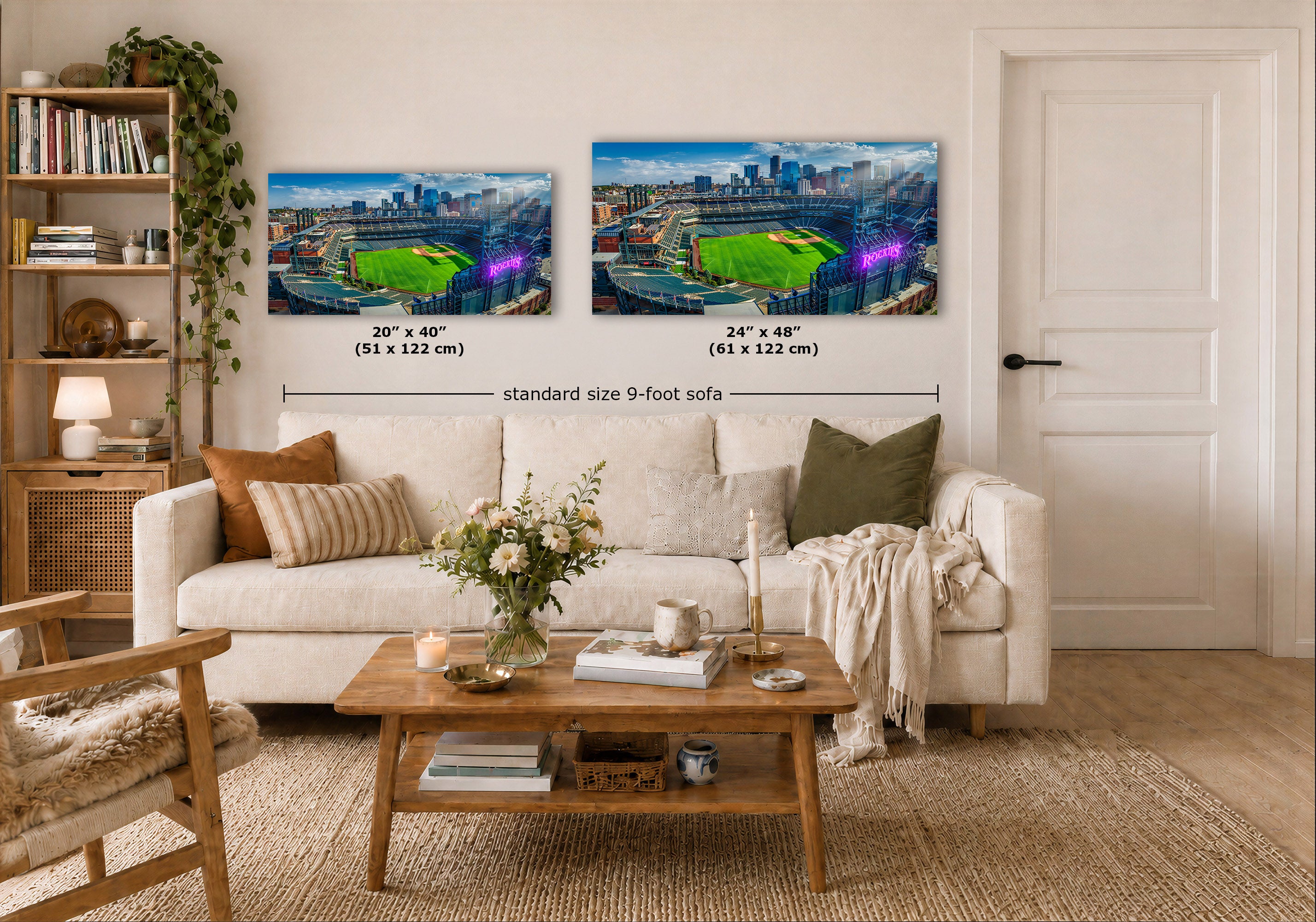 Two wall art prints showing a stadium scene are displayed above a white sofa in a styled living room. Black dimension lines and text indicate the sizes of the two prints as 20 x 40 inches and 24 x 48 inches, with a note reading 'standard size 9-foot sofa'.