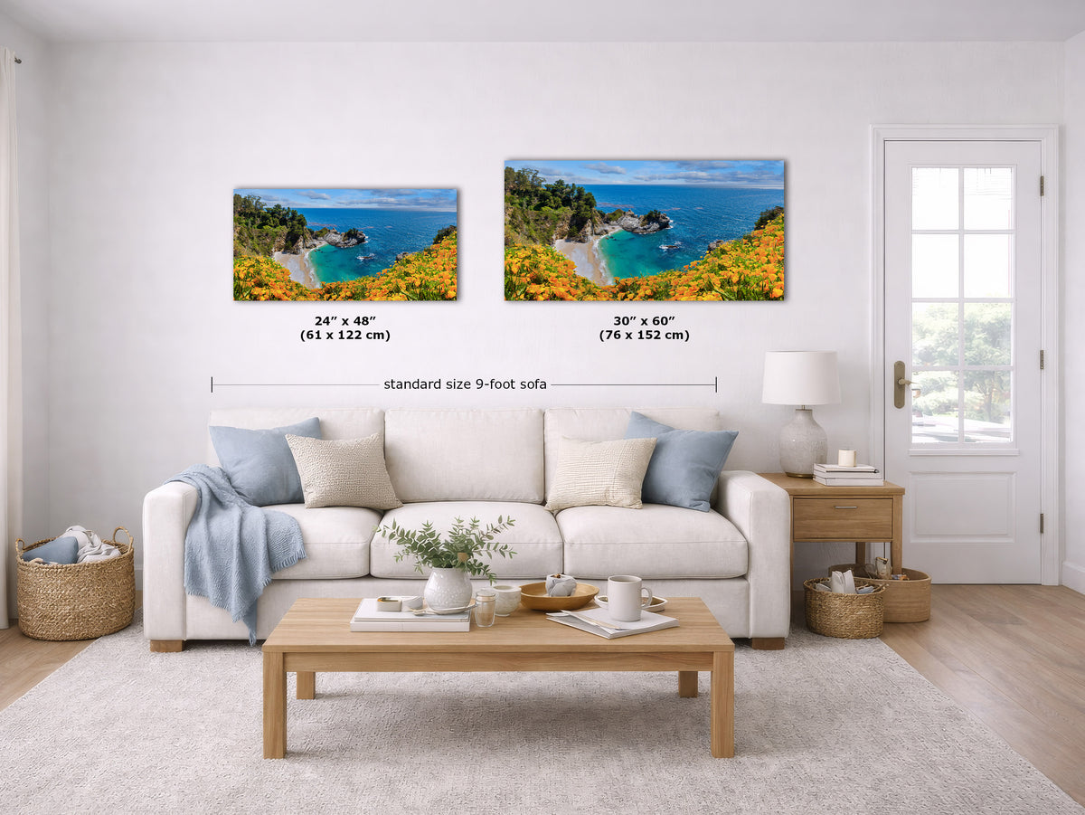 A staged living room with a white sofa, wooden coffee table, and wall art showing two coastal landscape prints. The prints include size callouts and a dimension line labeled standard size 9-foot sofa.