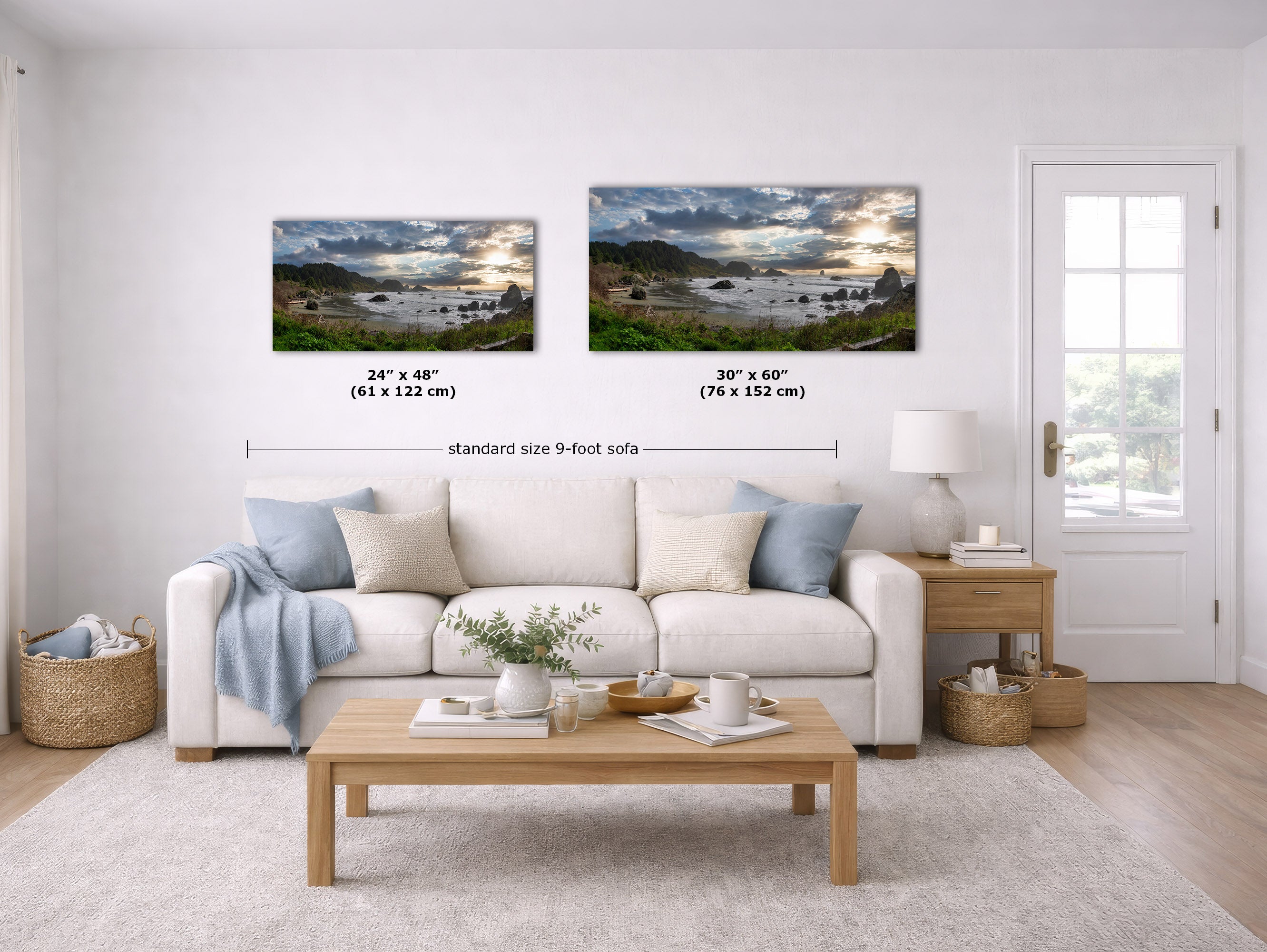 Two framed landscape wall art prints are shown above a white sofa in a bright living room. The left print is labeled 24 x 48 inches (61 x 122 cm) and the right print is labeled 30 x 60 inches (76 x 152 cm), with a dimension line between them reading standard size 9-foot sofa.