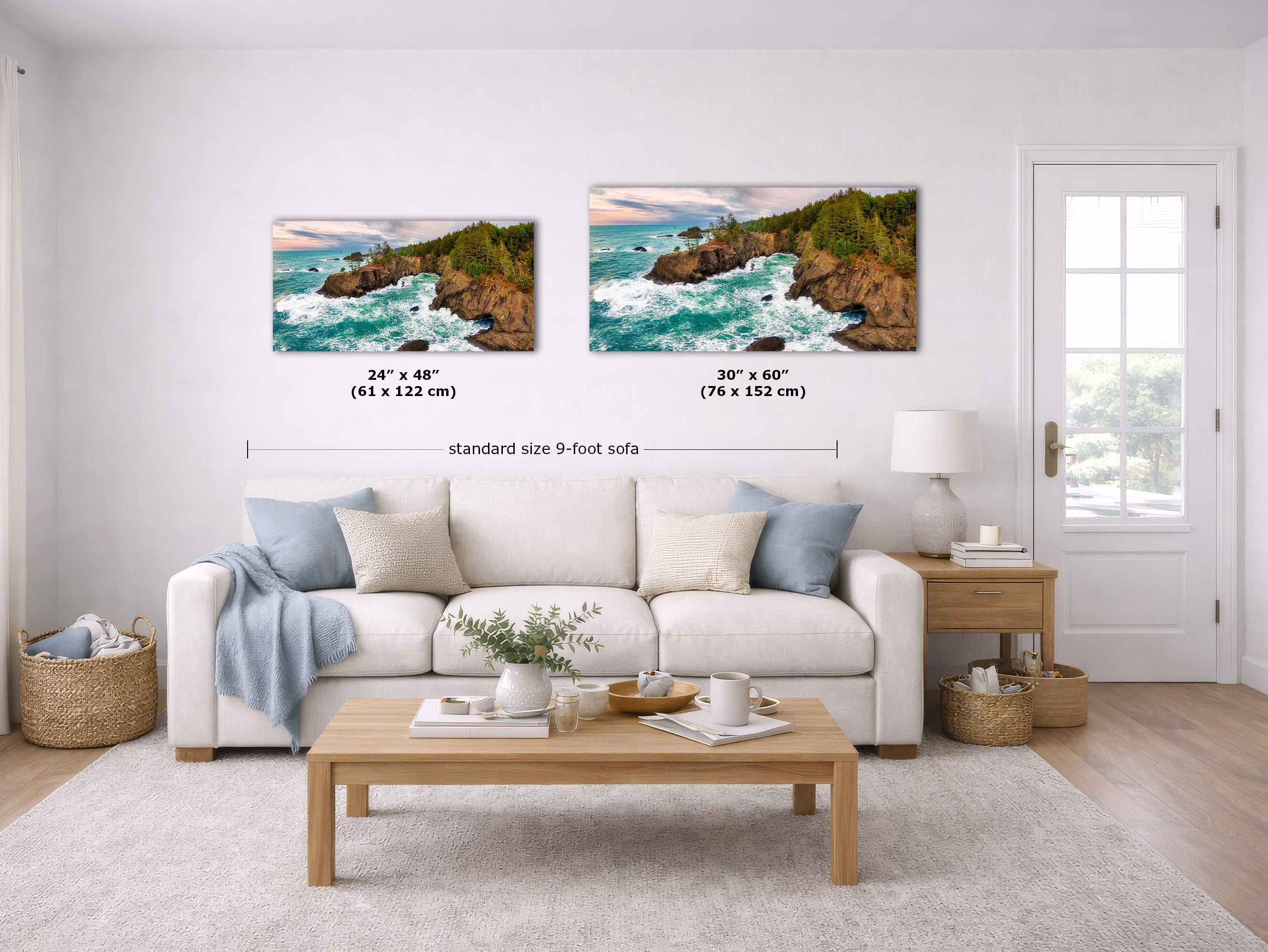 A staged living room shows two coastal landscape wall art prints above a white sofa. The prints depict rocky cliffs and turquoise ocean waves.
