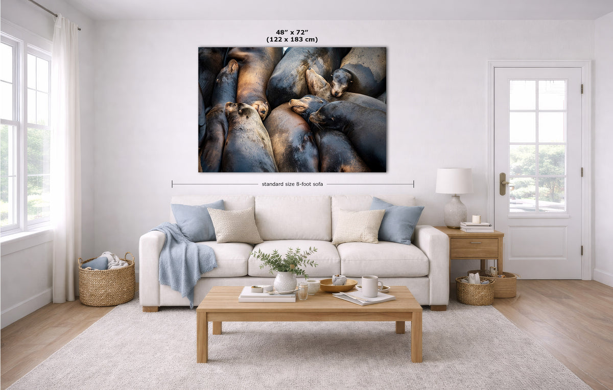 A large wall art print showing a close-up photograph of stacked brown and gray logs or bark, displayed above a white sofa in a bright modern living room. Measurement annotations indicate the print size as 48 x 72 inches.