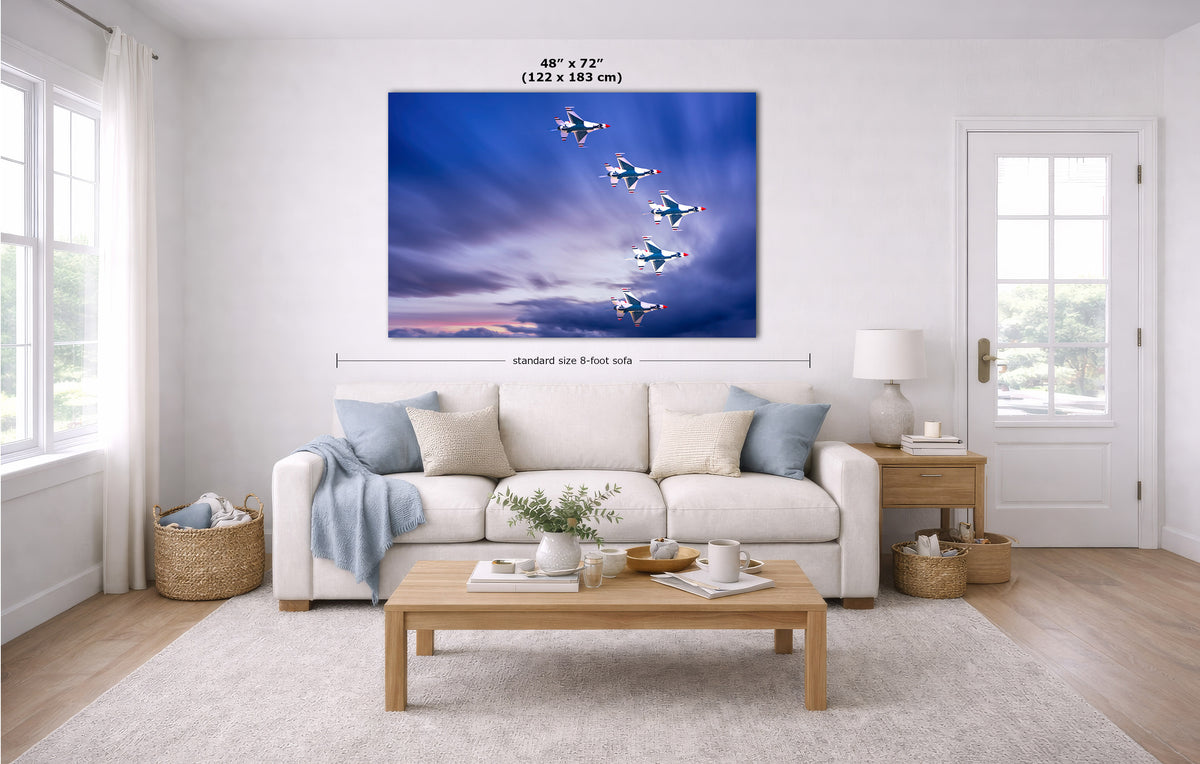 A large rectangular wall art print showing a formation of airplanes flying through a blue and purple sky, displayed above a white sofa in a bright modern living room. Measurement text and arrows indicate the print size as 48 x 72 inches (122 x 183 m).