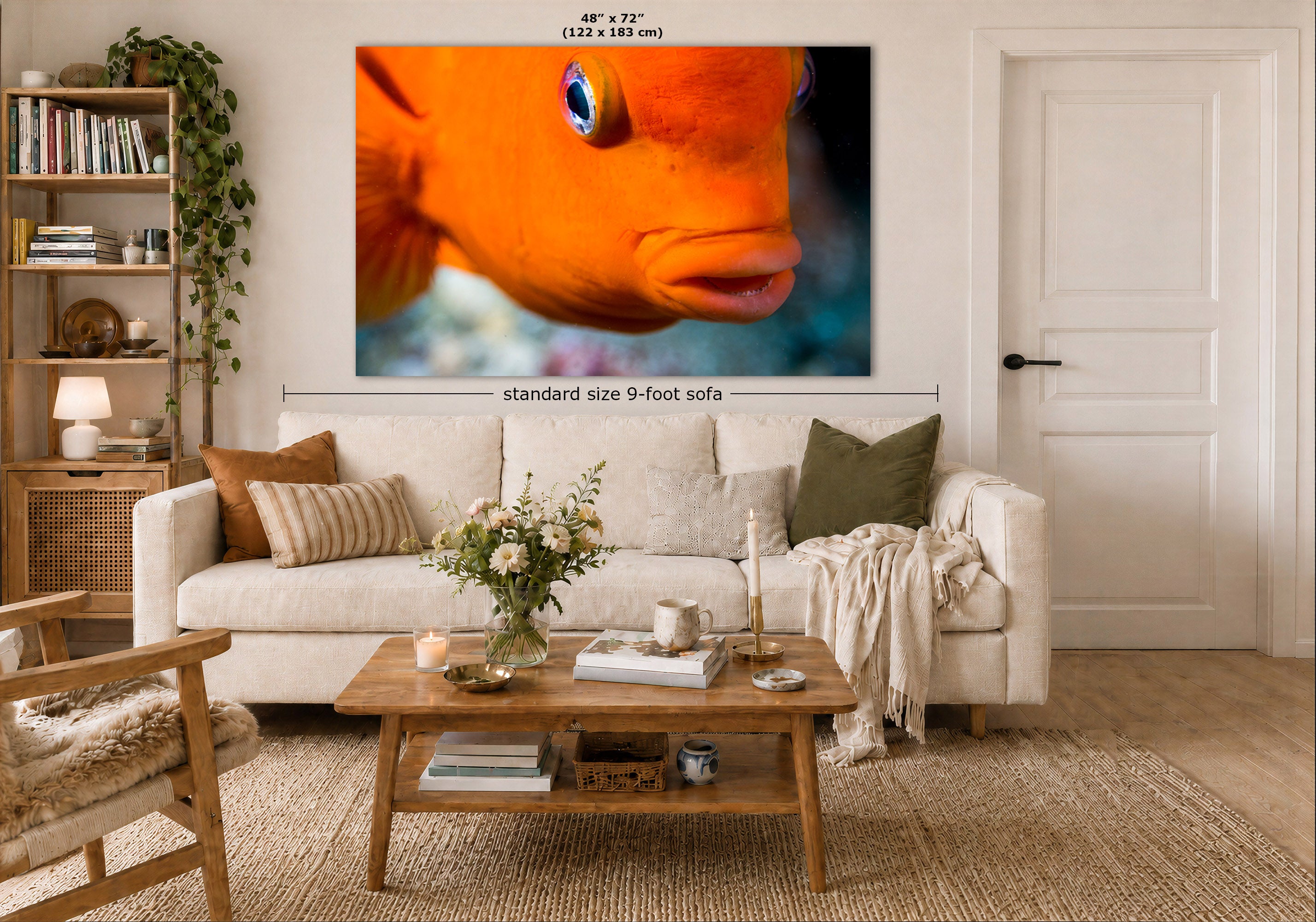 A large framed wall art print showing a close-up orange Garibaldi fish is displayed above a white sofa in a styled living room. Measurement text indicates the print is 48 x 72 inches, and a dimension line notes standard size 9-foot sofa placement.