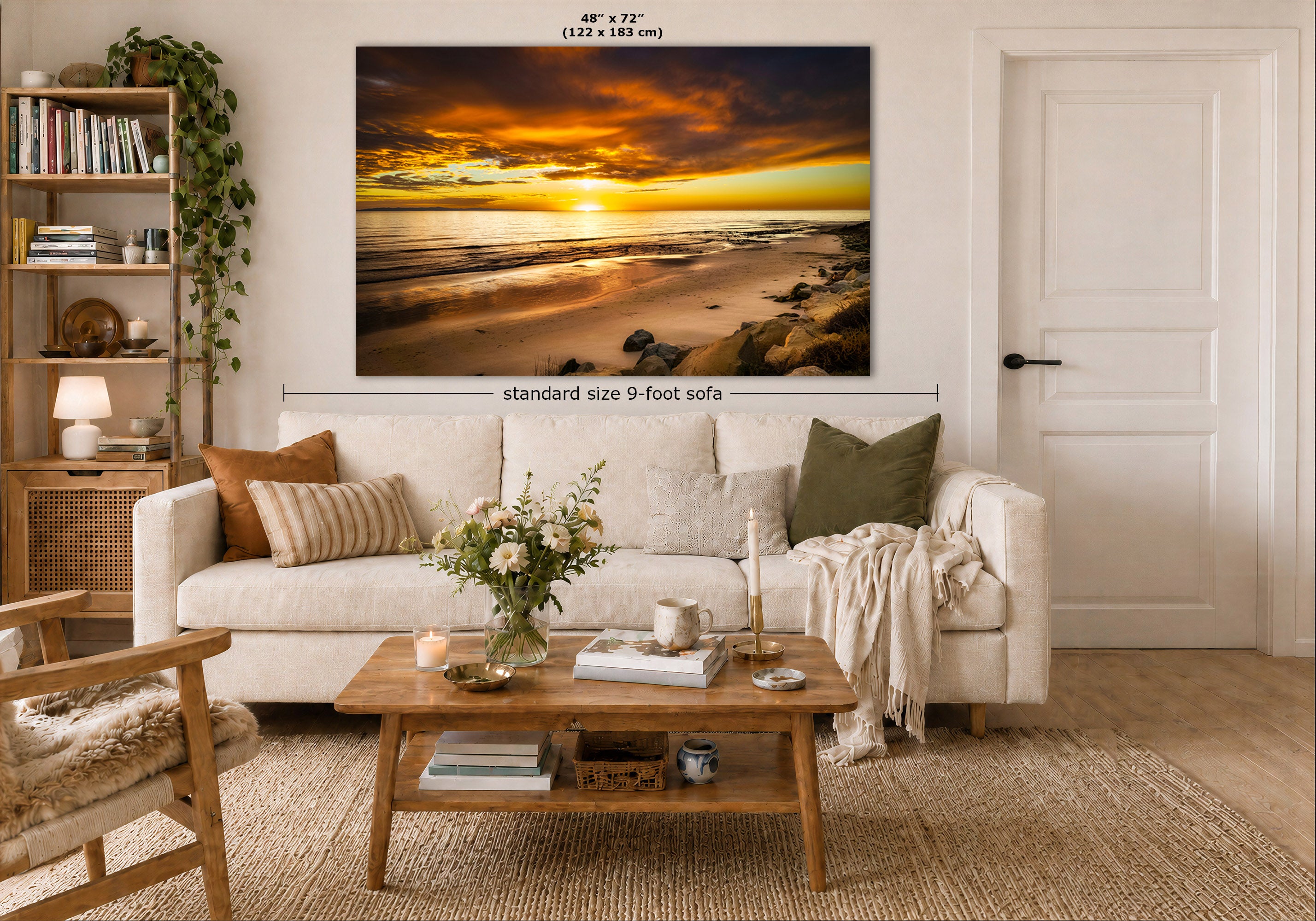 A large wall art print showing a dramatic sunset beach scene, displayed above a white sofa in a styled living room. The image includes dimension labels indicating the print is 48 x 72 inches and the sofa is standard size 9-foot.