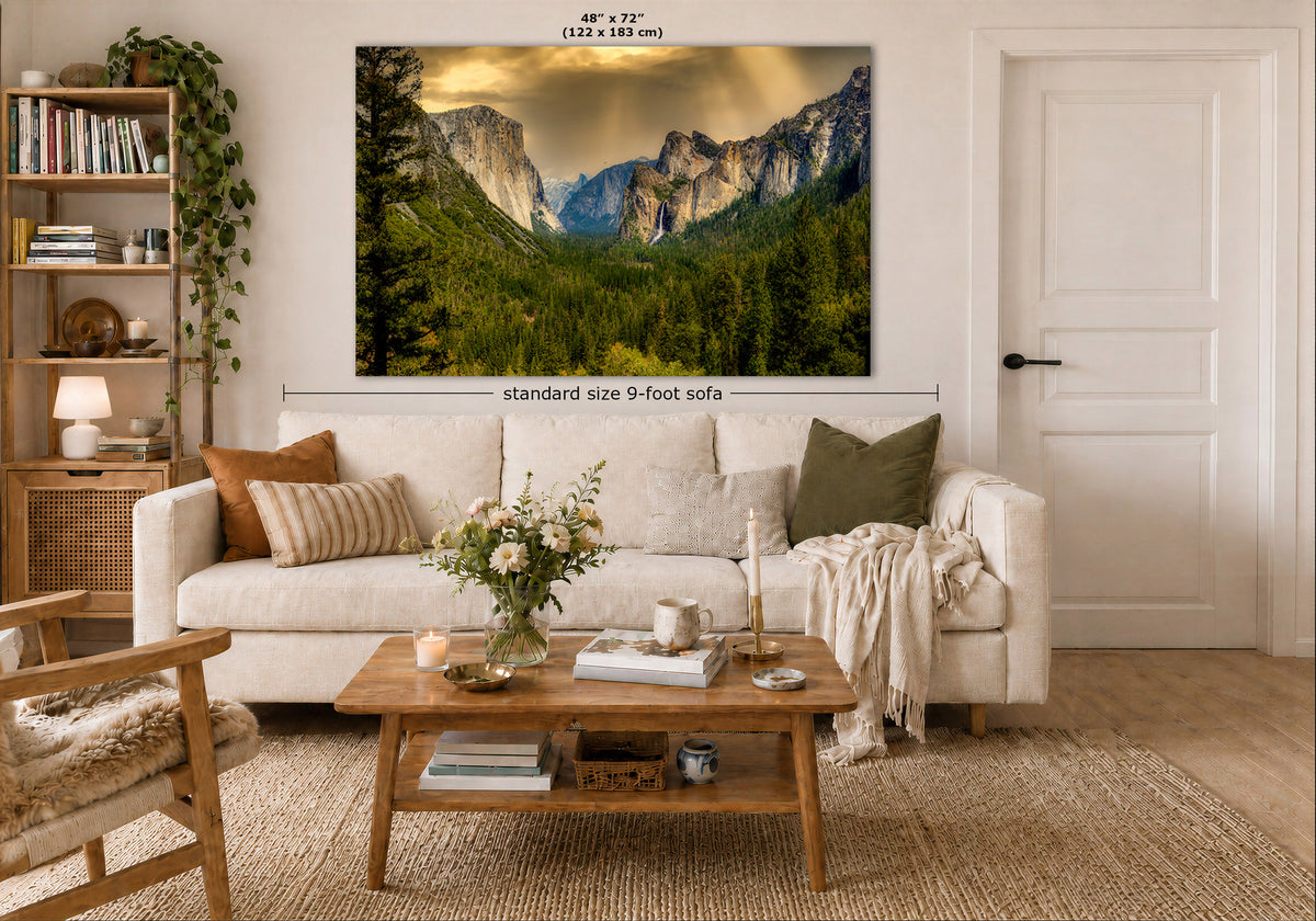 A large wall art print showing a mountain valley landscape is displayed above a white sofa in a styled living room. The print includes size markings reading 48 x 72 inches and a note about standard size 9-foot sofa.