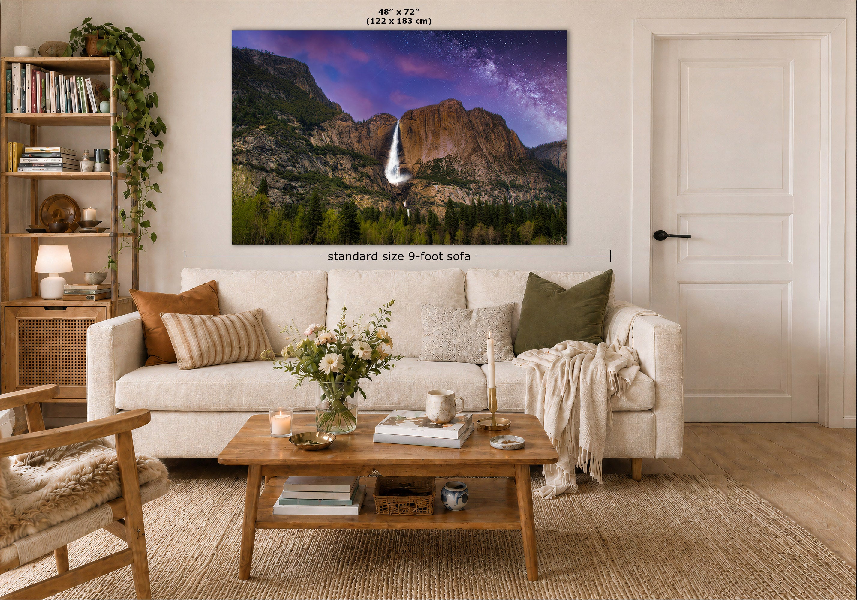 A framed wall art print showing a mountain landscape with a waterfall and purple sky, displayed above a white sofa in a styled living room. Text on the image indicates the print size as 48" x 72" (122 x 183 in) and notes standard size 9-foot sofa context.