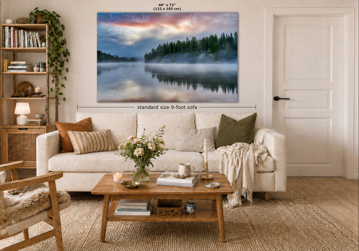 A large landscape canvas print of a misty forest lake, shown hanging on a wall in a modern, neutral-toned living room mockup. The image includes dimension labels indicating the canvas is 48" by 72" (122 x 183 cm) and is displayed above a 9-foot sofa.