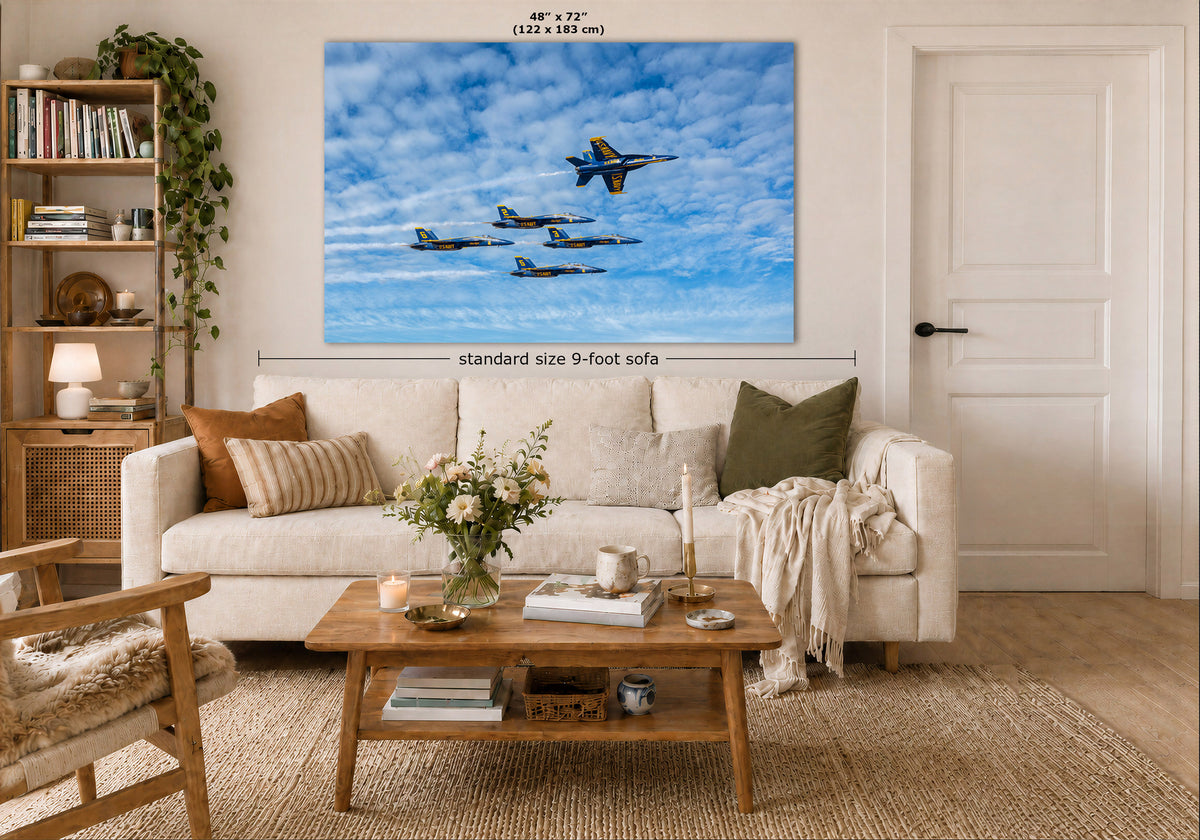 A large square canvas wall art print showing a formation of fighter jets flying through a bright blue sky with white clouds, displayed above a white sofa in a modern, well-lit living room. The image includes dimension labels indicating the print is 48" x 72" (122 x 183 cm) and the sofa is standard size 9-foot.
