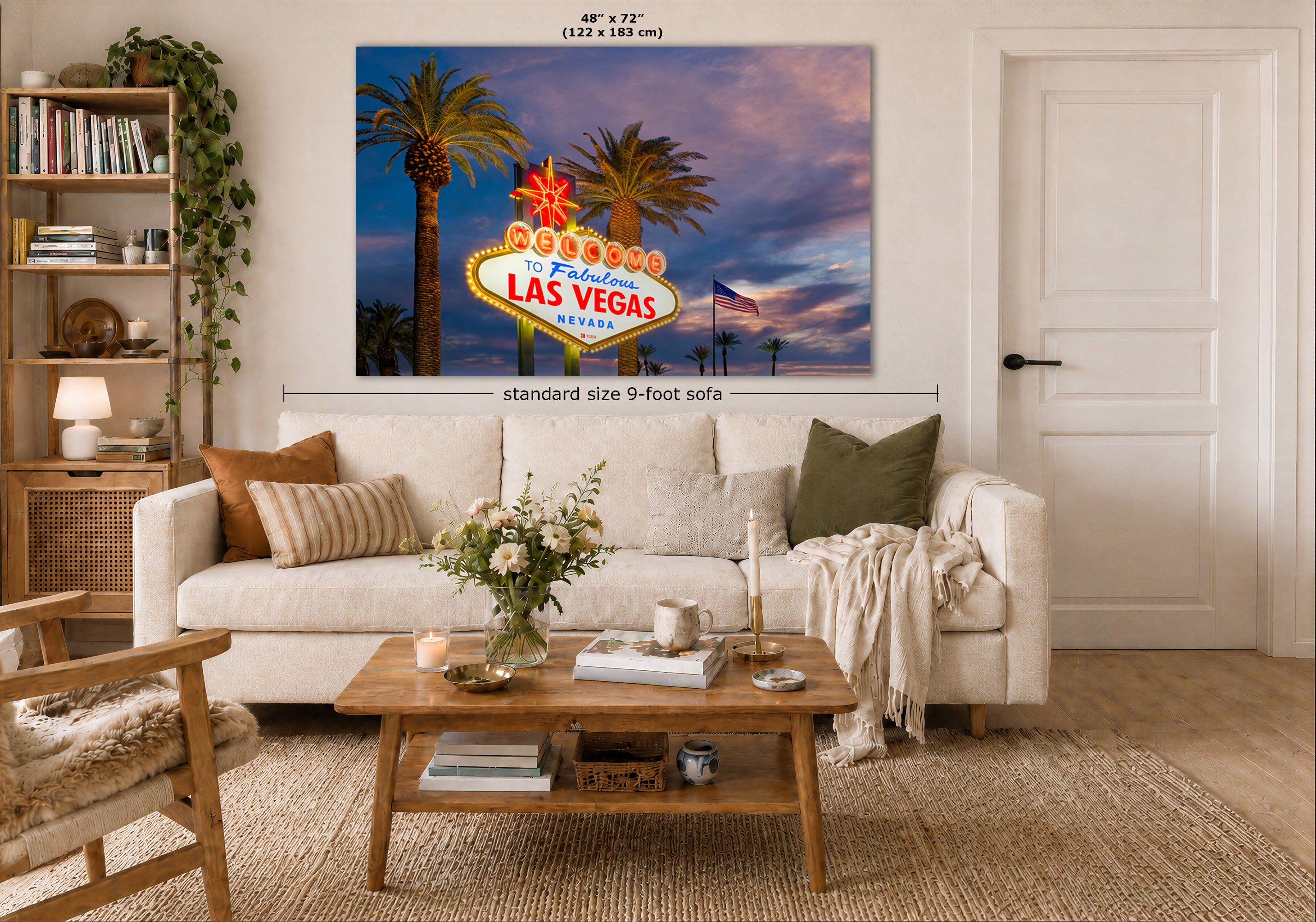 A large canvas wall art print depicting the Las Vegas sign at sunset, displayed in a modern living room mockup above a white sofa. The image includes dimension lines indicating the print is a standard 9-foot size.